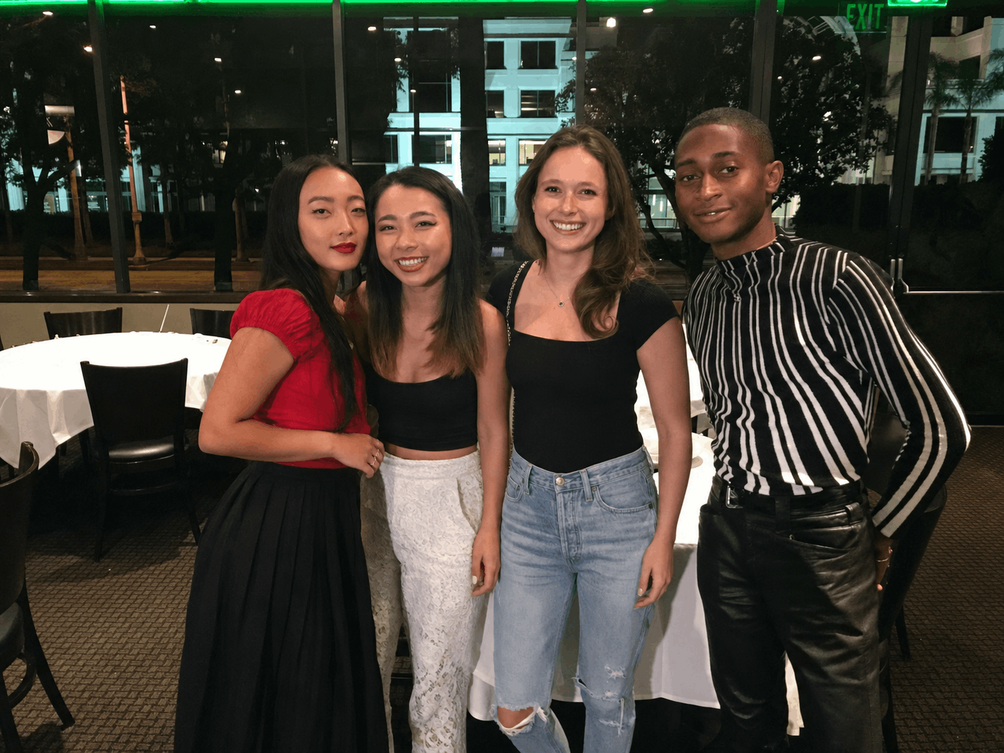 Friends enjoying a group night out together at a murder mystery dinner event
