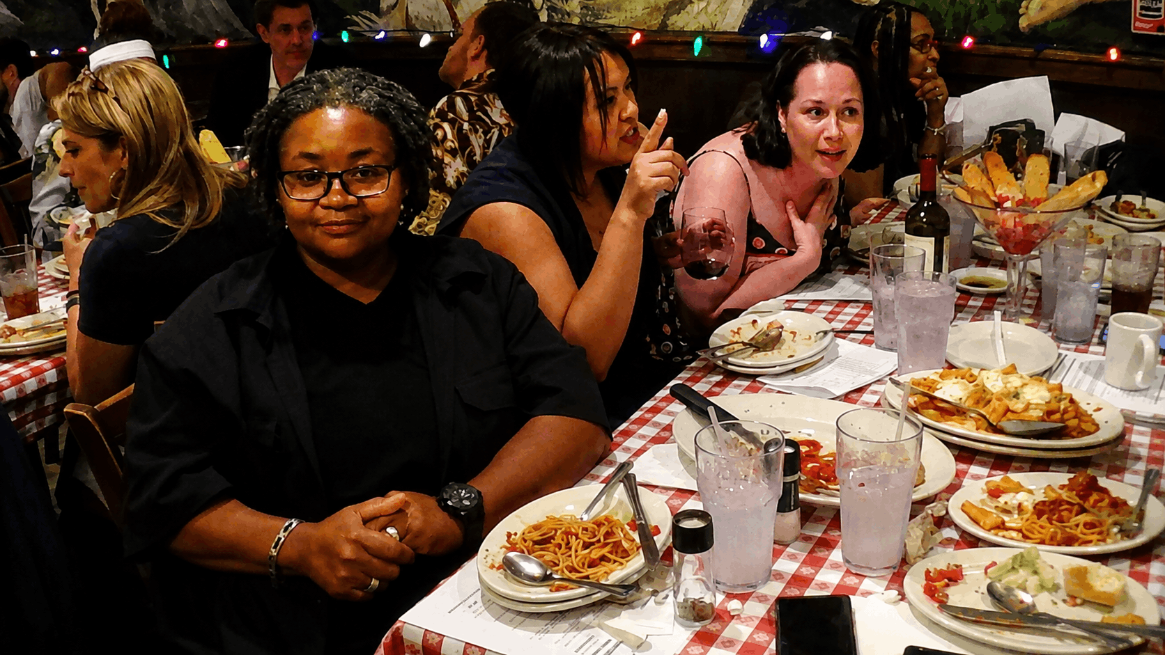 Friends and family enjoying a murder mystery dinner show together