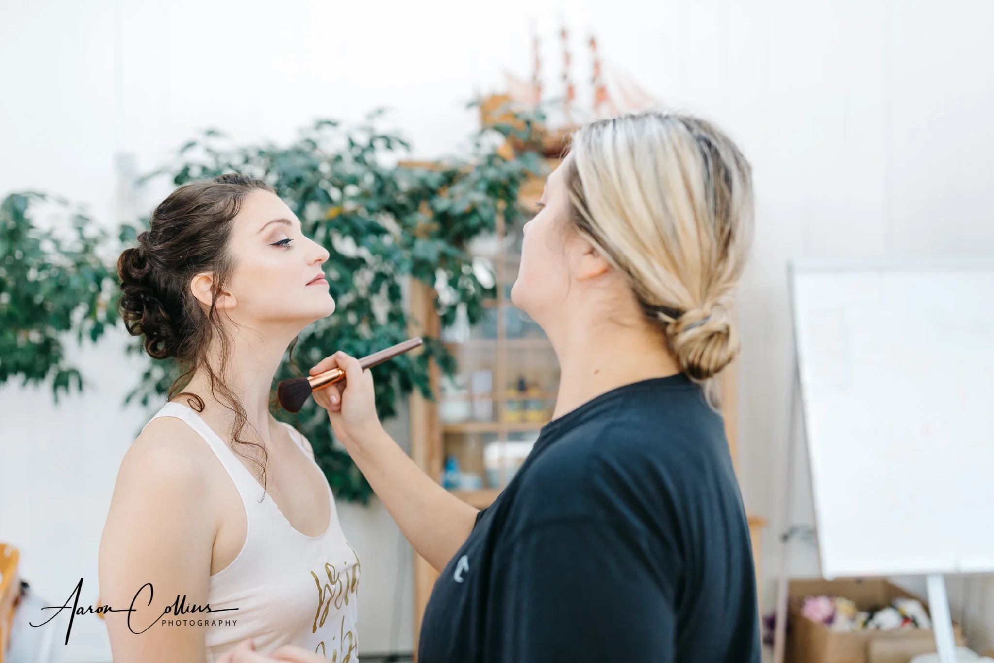 Taylor Wiggins putting makeup on the bride at Villakula on Block Island