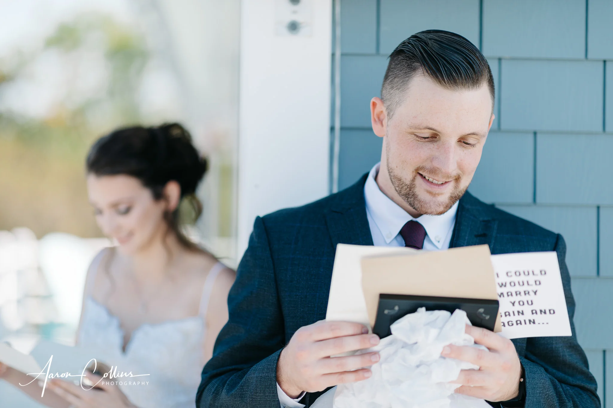 Groom looking at his gift while bride is concealed around the corner.