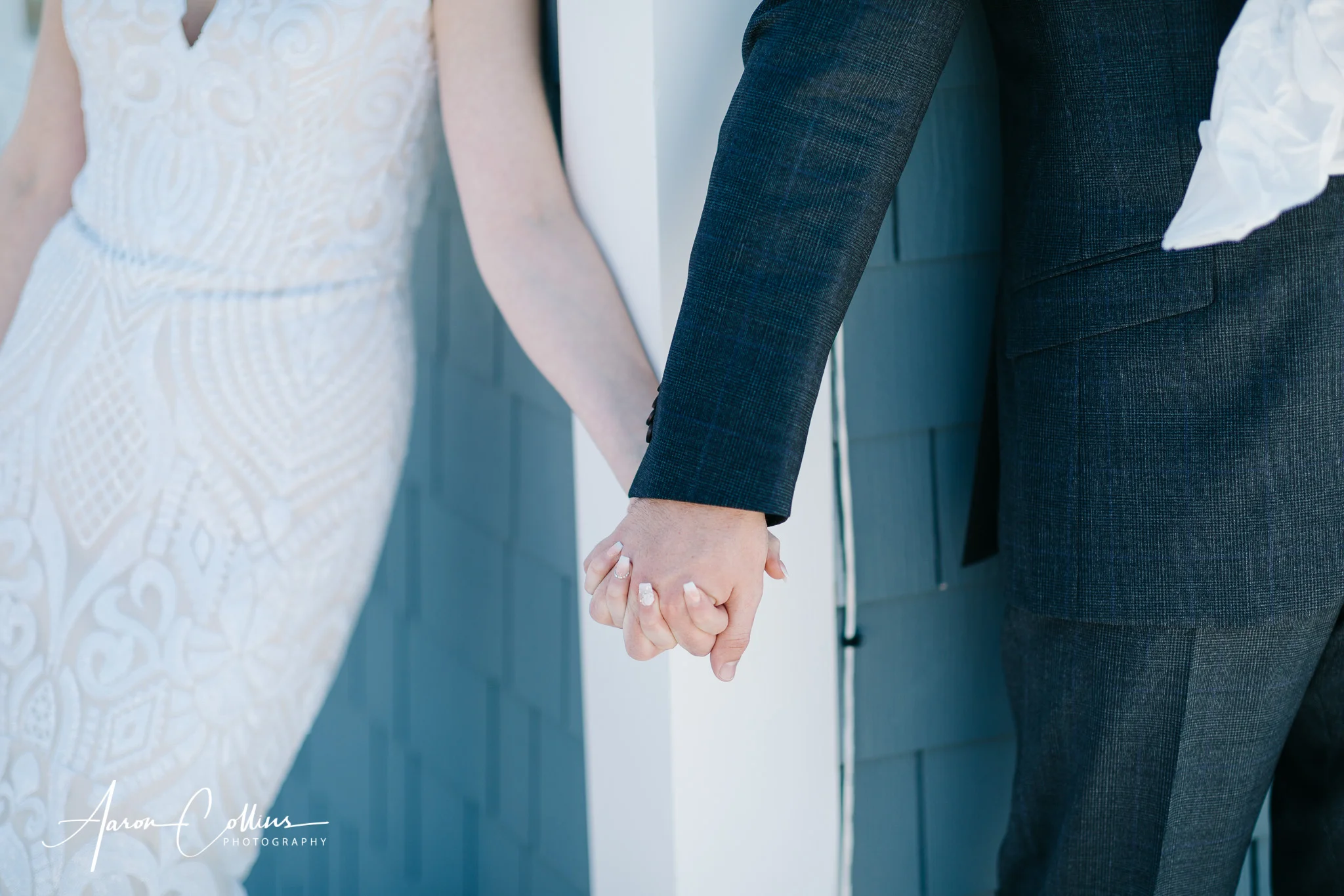 Bride and groom holding hands after they exchange gifts
