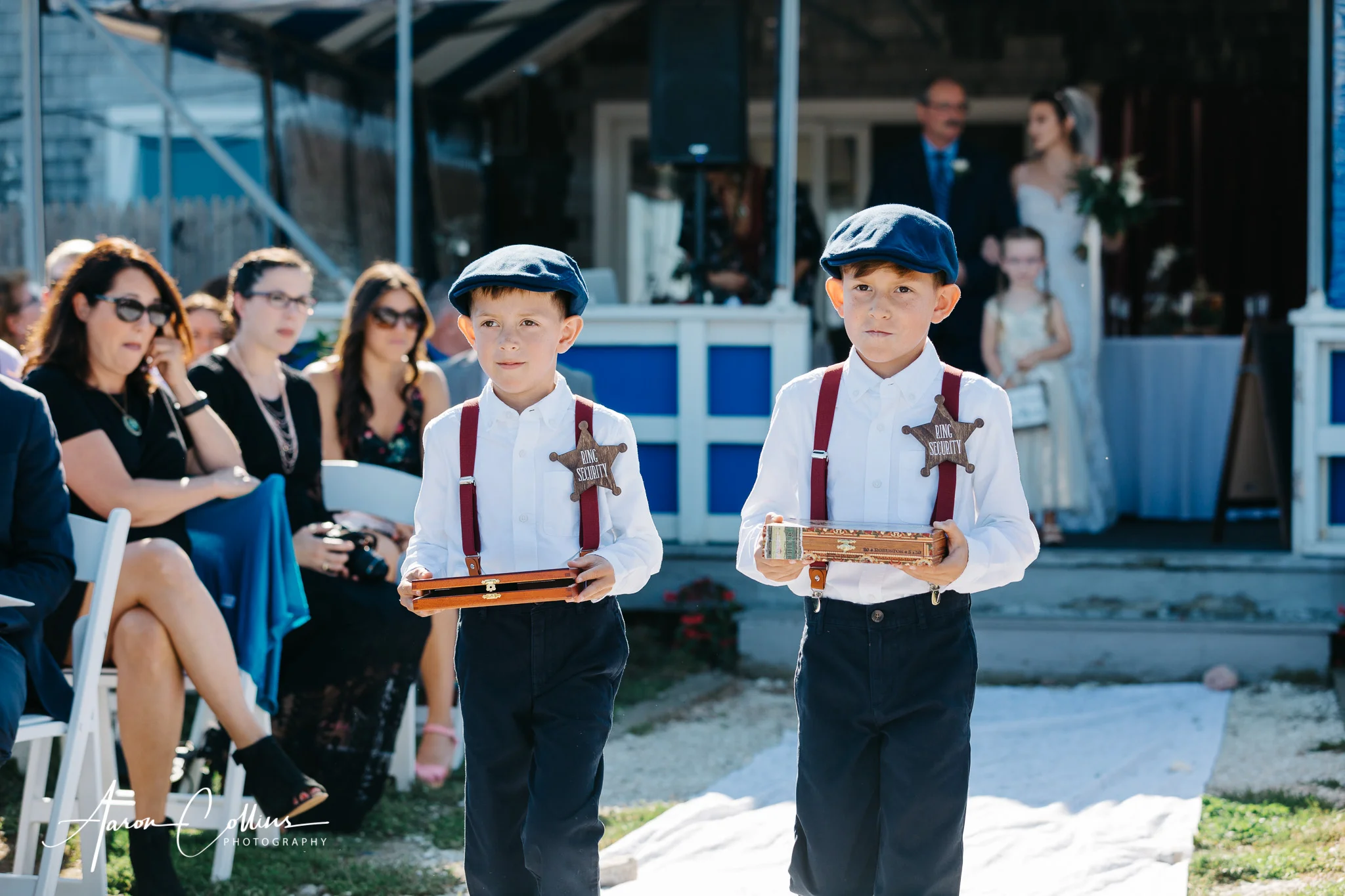 The ring bearers, wearing “ring security” badges as they dress in prohibition era costumes walking down the aisle.