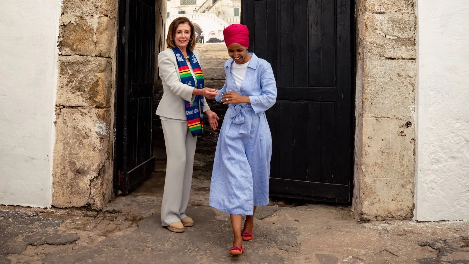 Cropped photo taken from a Tweet from Ilhan Omar, saying: They said “send her back” but Speaker @SpeakerPelosi didn’t just make arrangements to send me back, she went back with me ✊🏽 So grateful for the honor to return to Mother Africa with the @TheBlackCaucus and commemorate The Year of Return! #Doorofreturn #Ghana