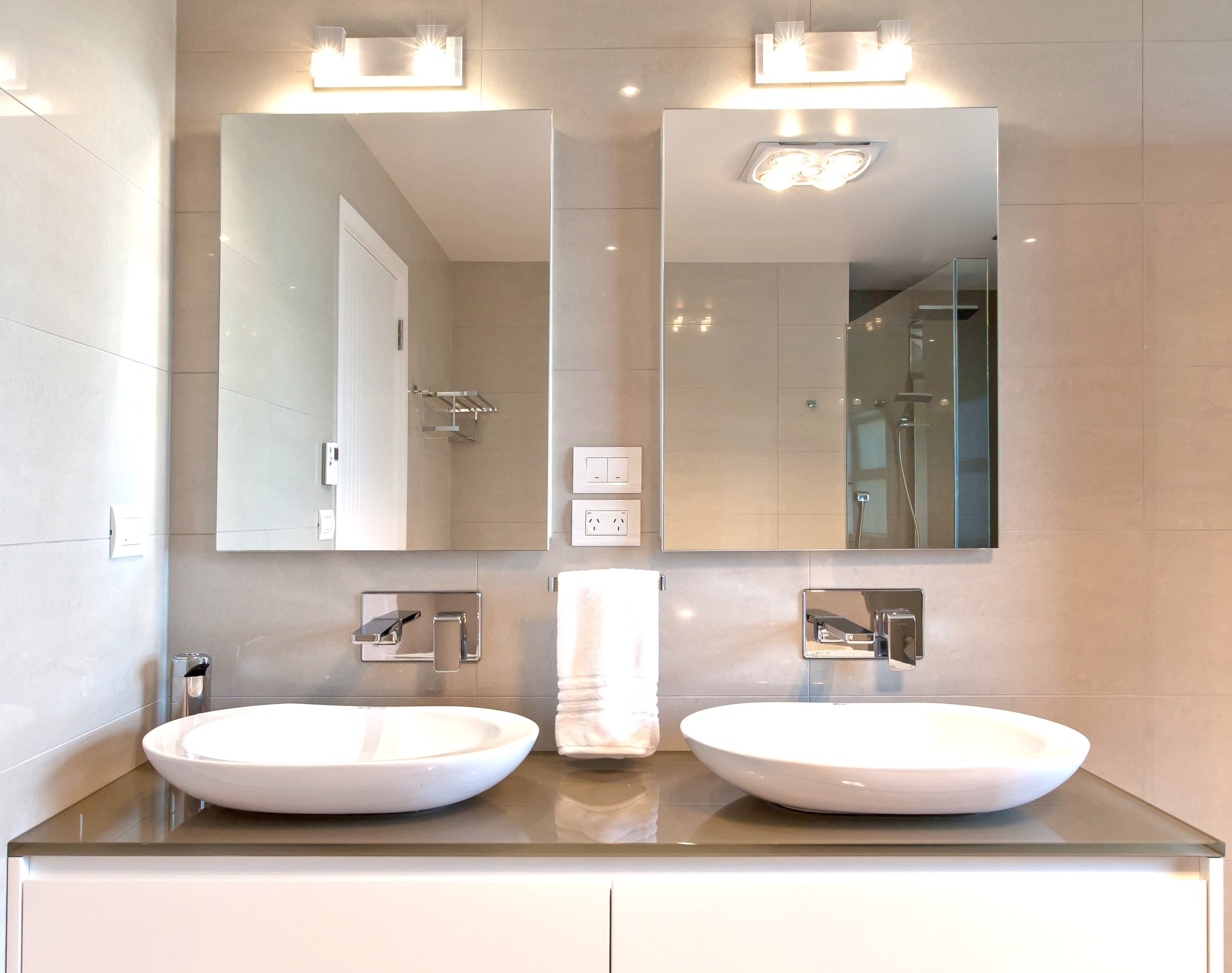 Square bathroom mirror cabinets in tiled bathroom