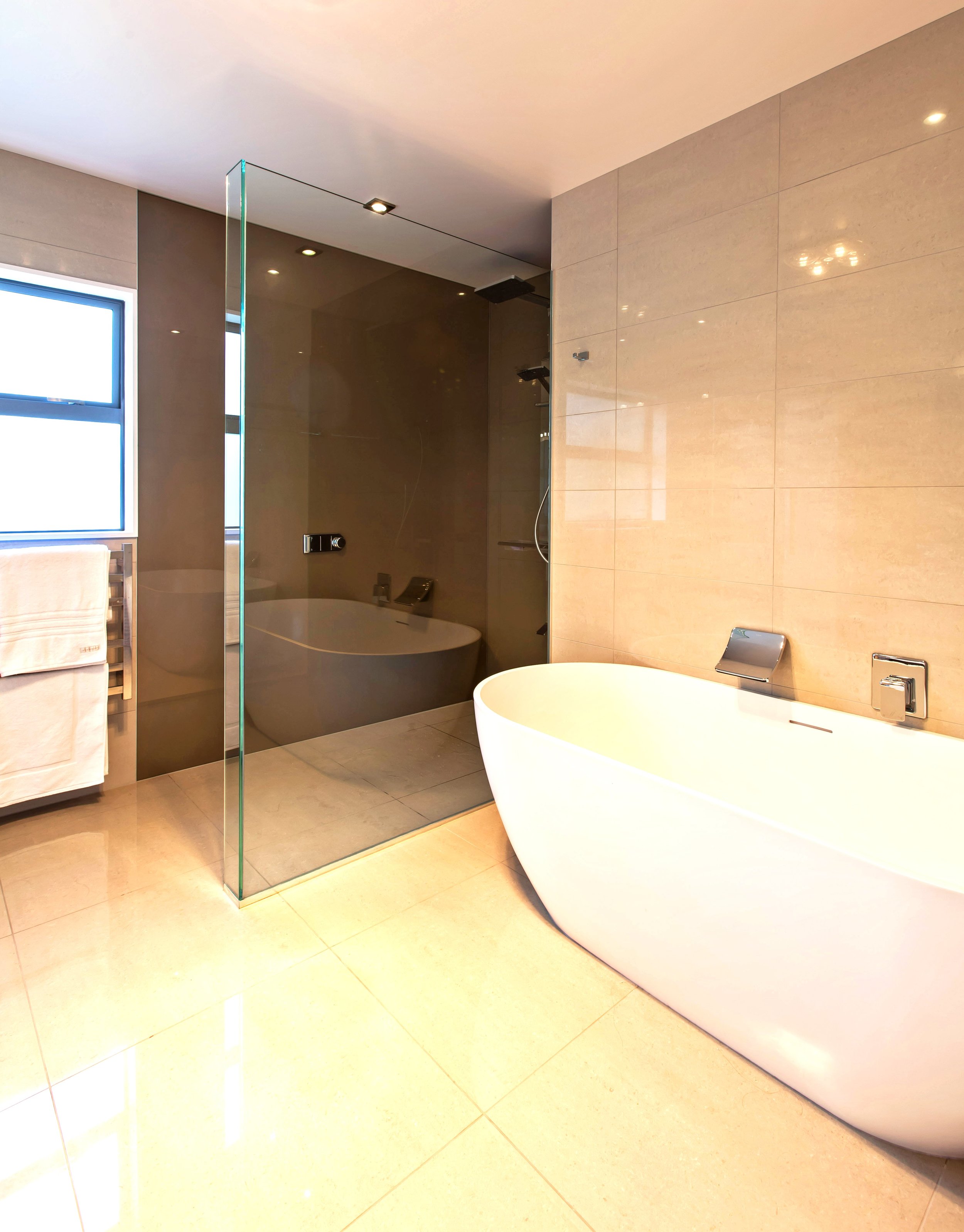 Frameless glass shower in master bathroom