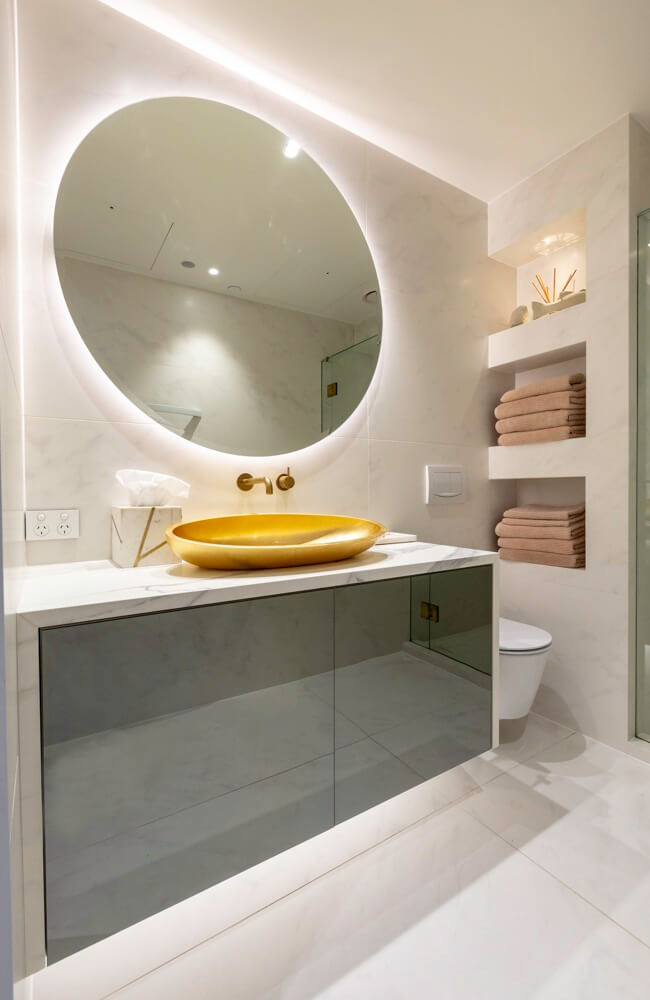 Round mirror in small apartment bathroom