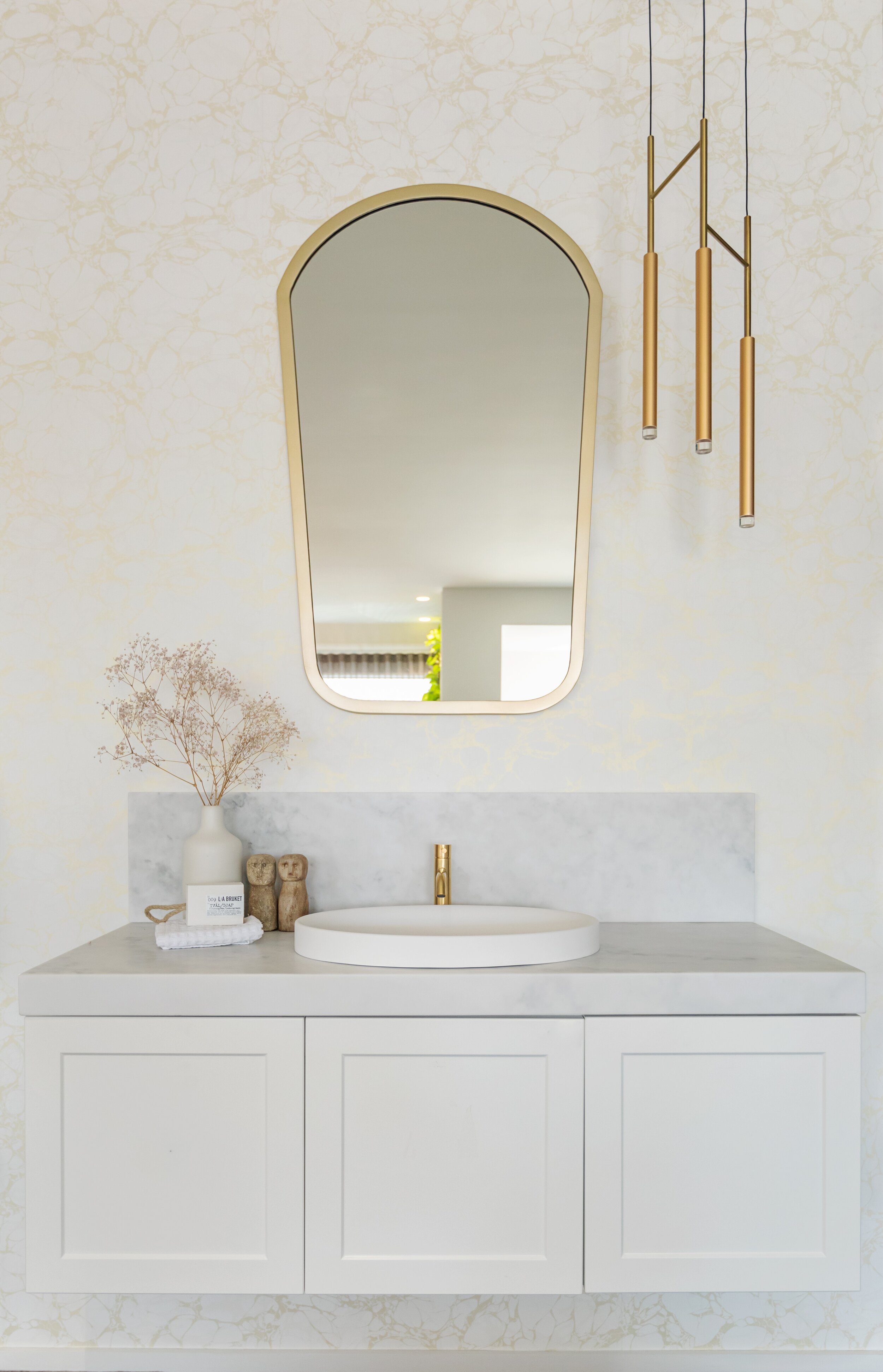 Shaped bathroom mirror in gold frame