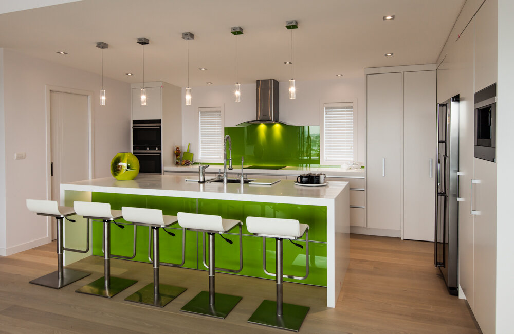 Glass featured in island back of modern white kitchen