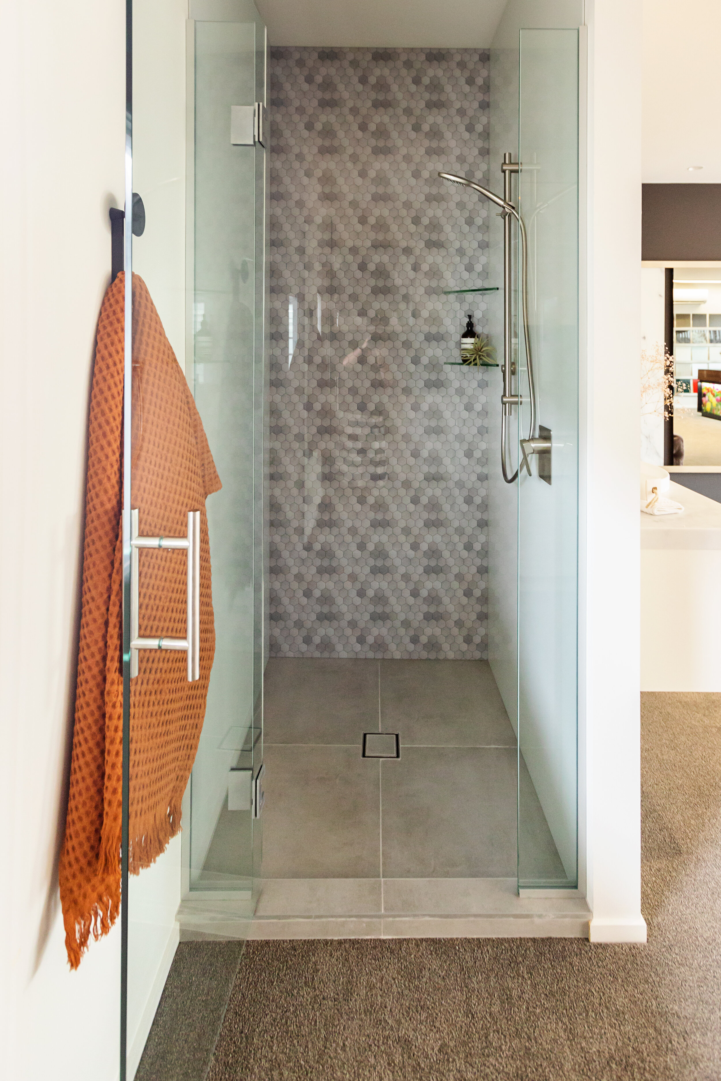 Inline frameless shower with printed and painted glass wall panels