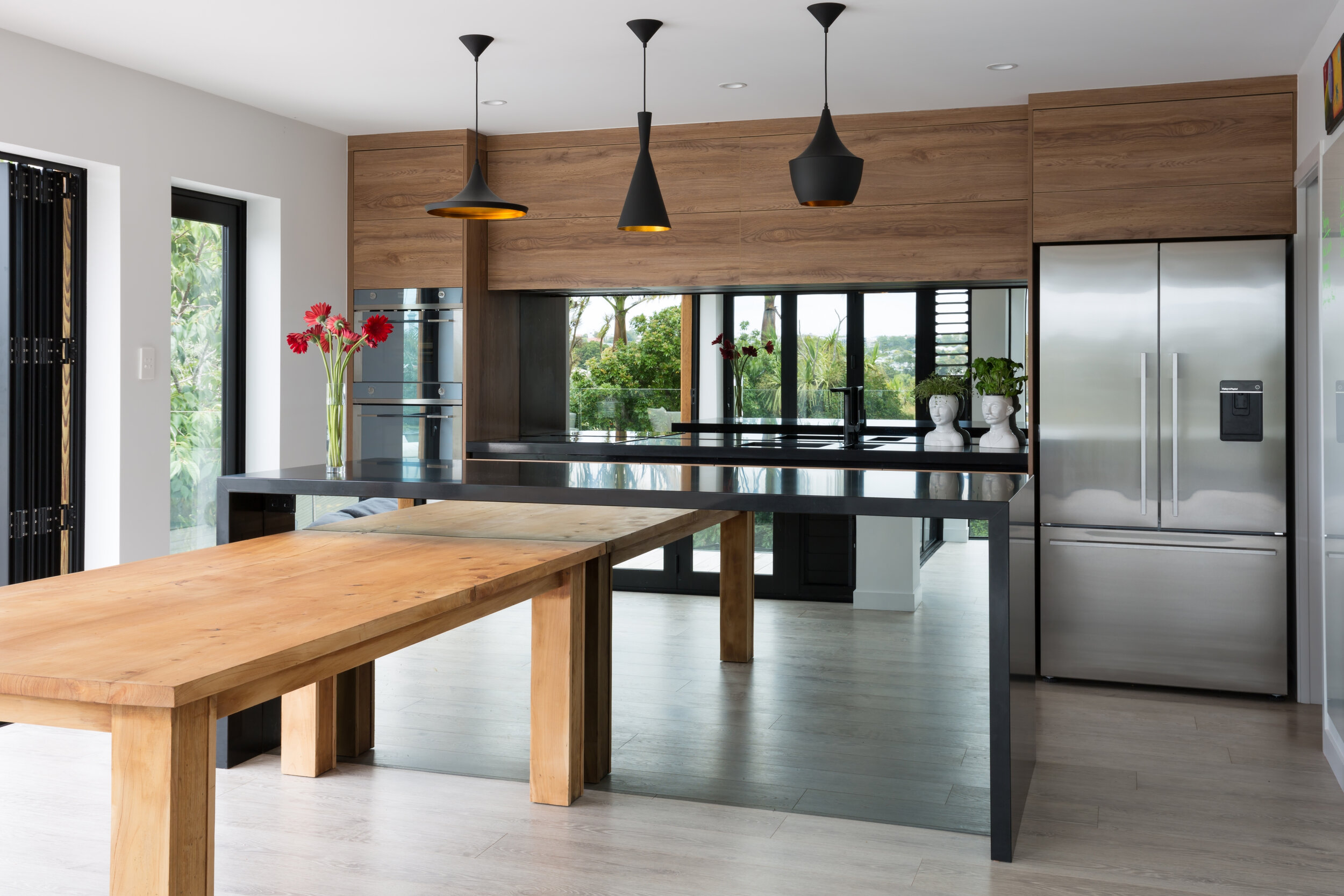 Smokey mirror splashback reflecting the view from the kitchen