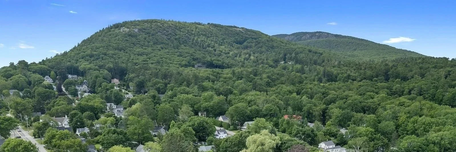 View looking towards Mount Battie overlooking Camden harbor, islands, and Penobscot Bay