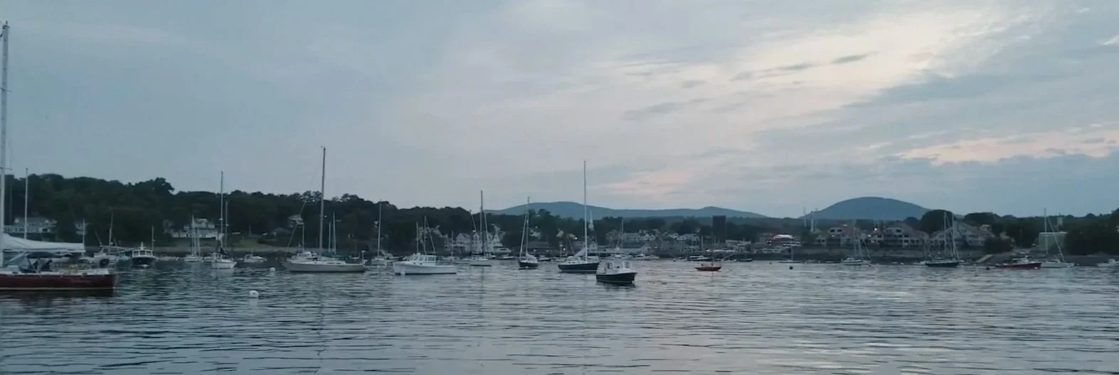 Historic schooners sailing in Camden Harbor along the coast of Maine