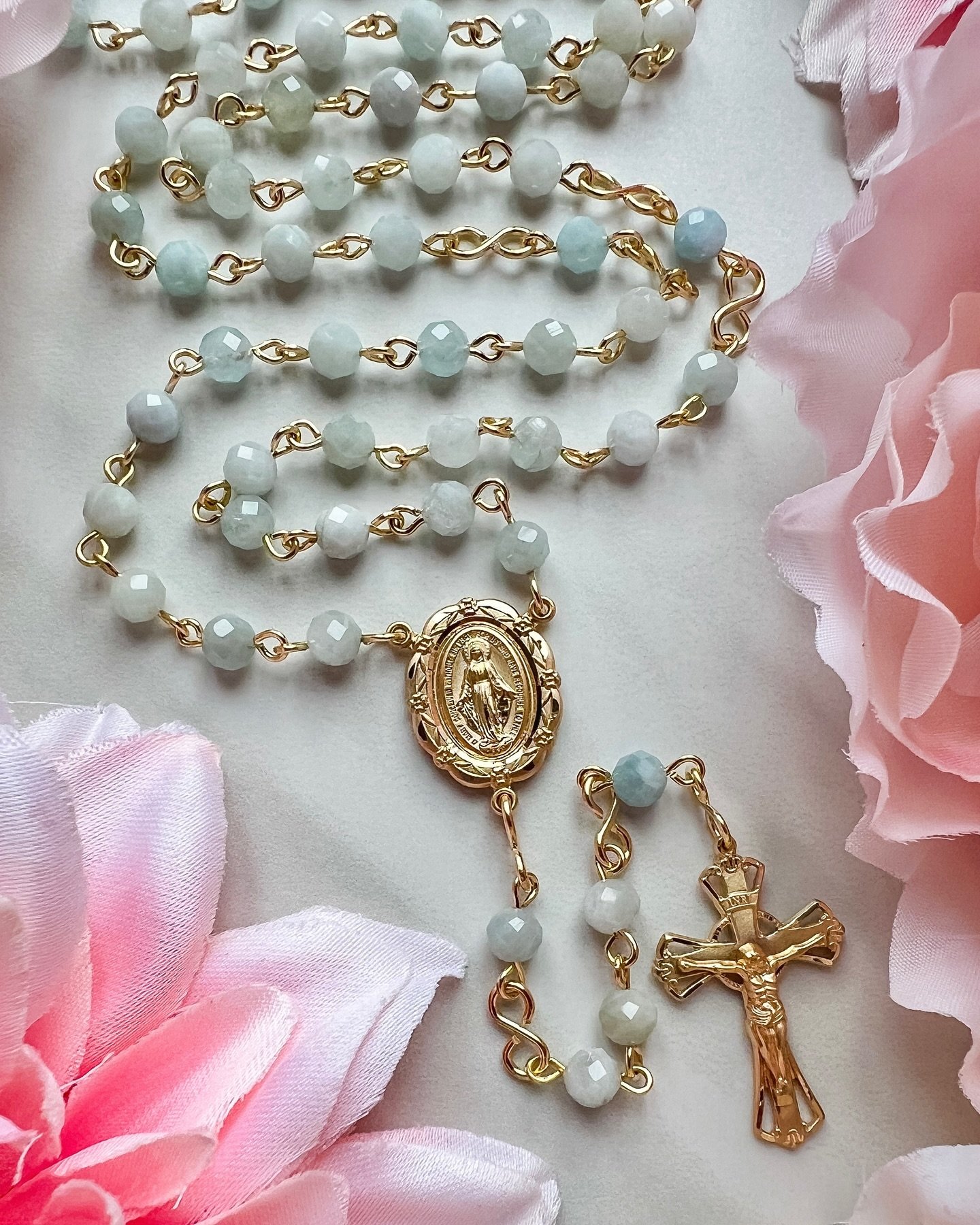 14k gold and aquamarine 💛

Aquamarine is the March birthstone! These faceted beads catch the light and have a lovely pale blue color. The Miraculous Medal with floral border is so detailed and beautiful, and pairs well with the crucifix and beads. 1