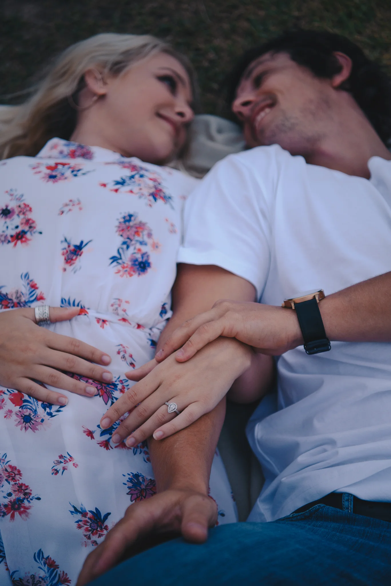 bride and groom lying down holding hands during a pre wedding shoot