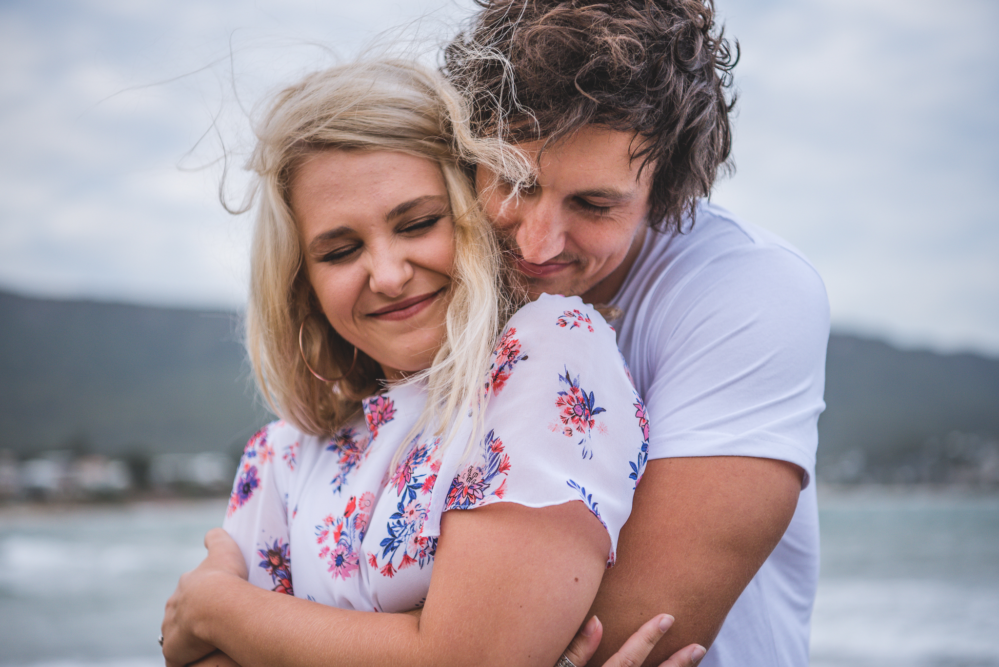 cuddles on the beach in pre wedding photo shoot