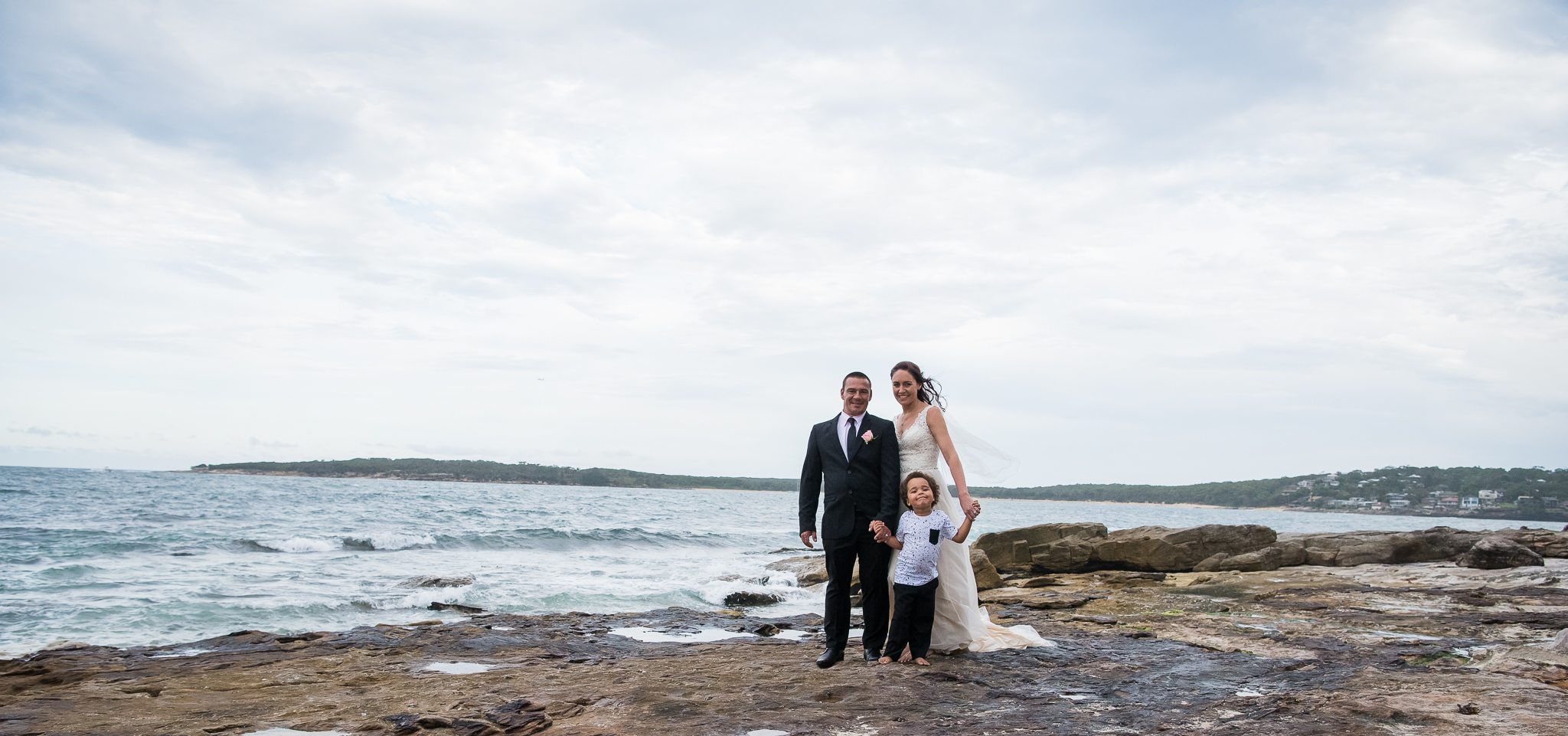 panoramic image of bridal party at the beach sydney