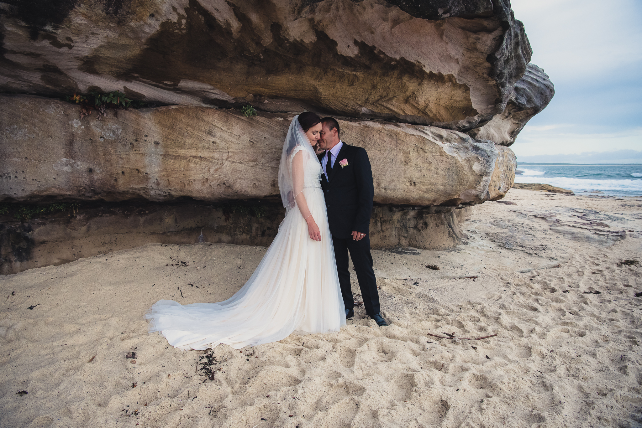bride and groom on the beach during wedding photos