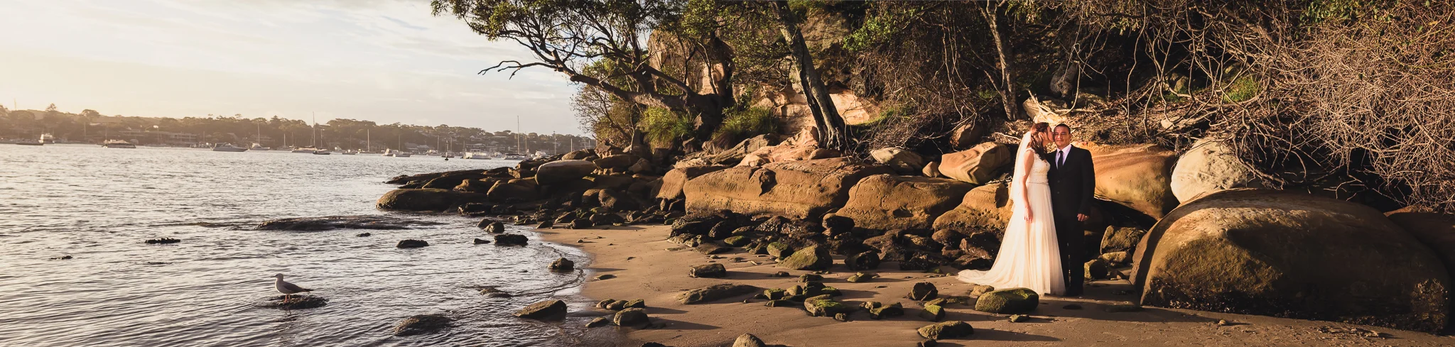 panoramic photo of bride and groom at sunset on the beach