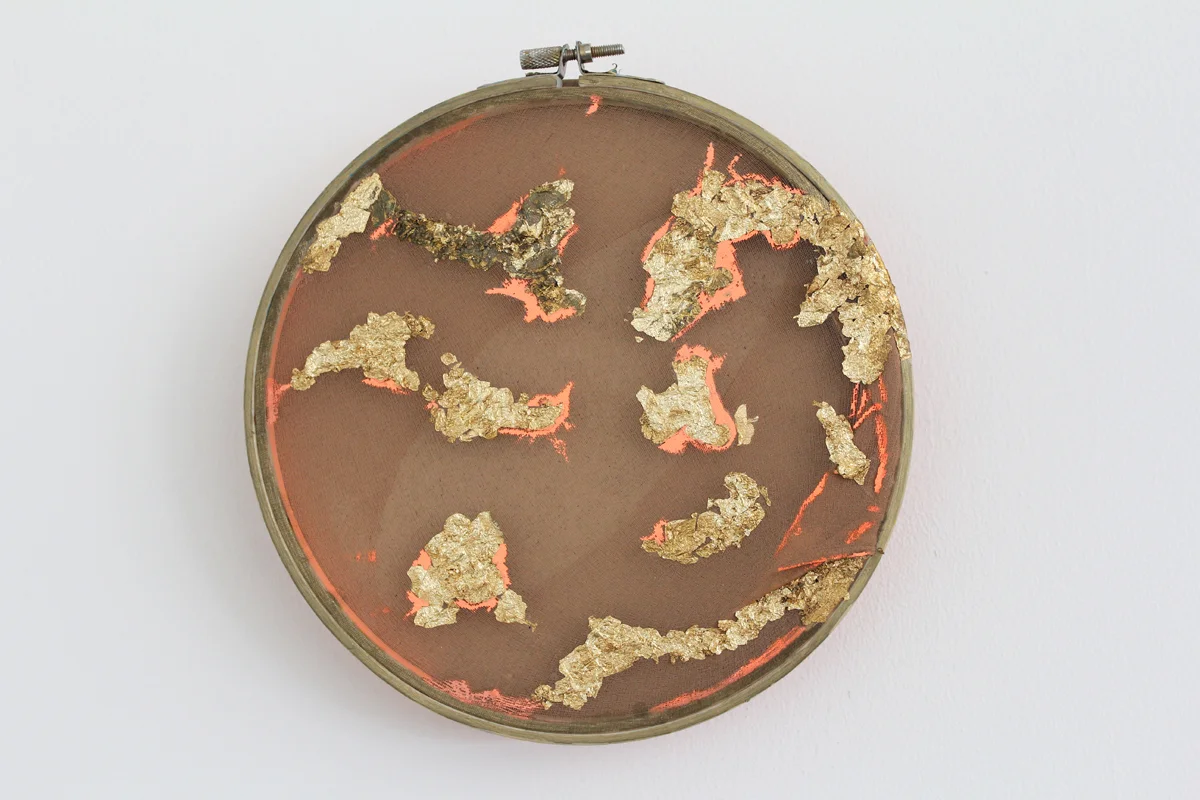 2018, gold flakes and acrylic on stockings over embroidery hoop