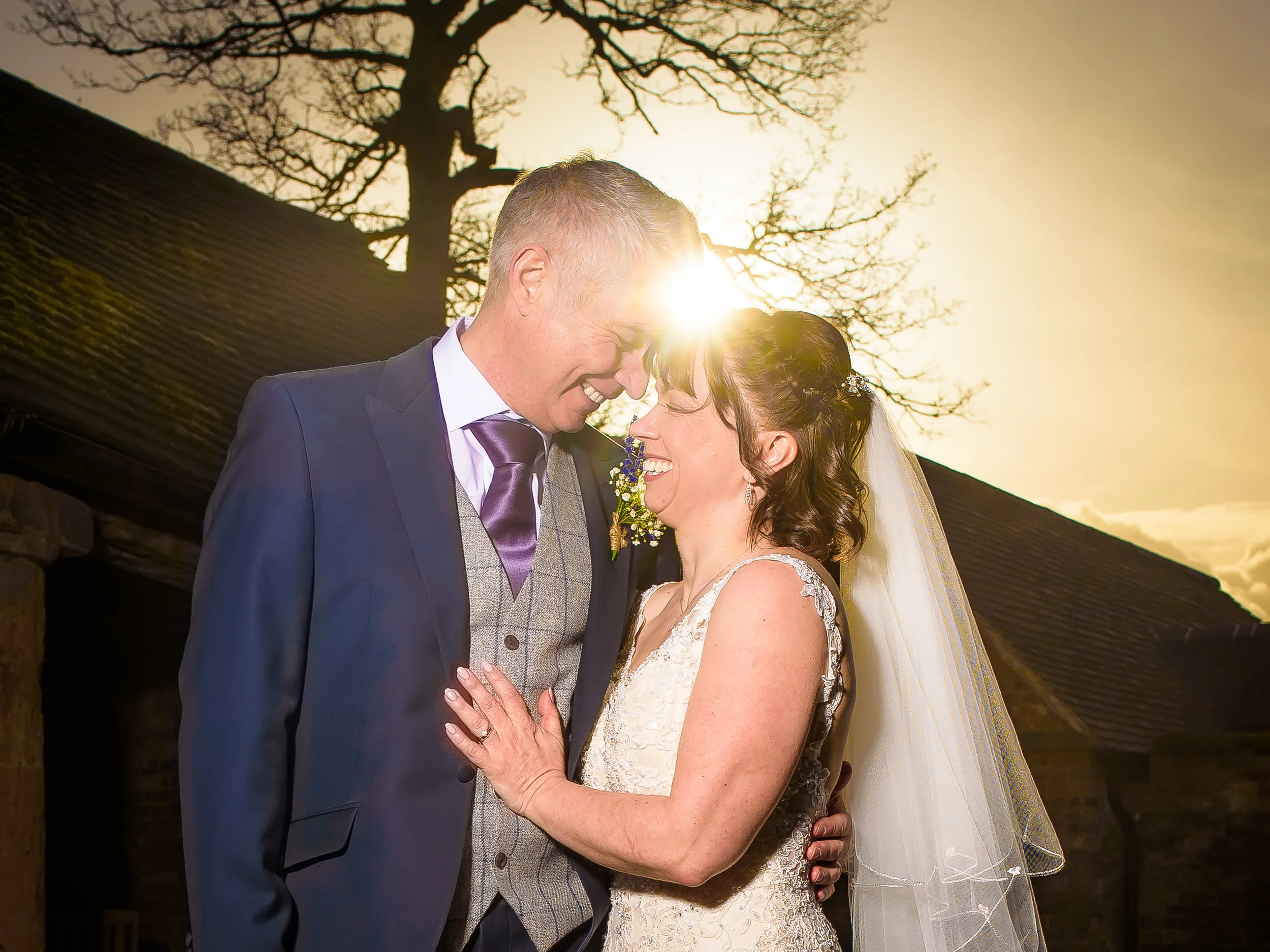 Bride and groom embracing outdoors on their wedding day in Warwickshire, photographed on real film.