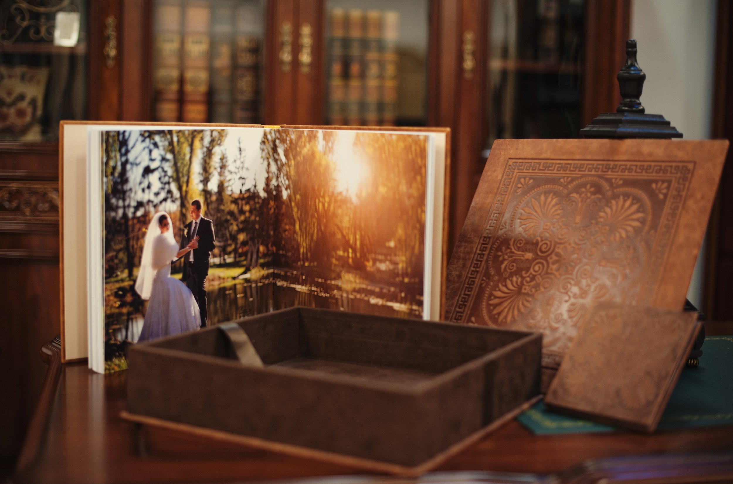 Fine-art wedding album and presentation box showing a real film wedding photograph.