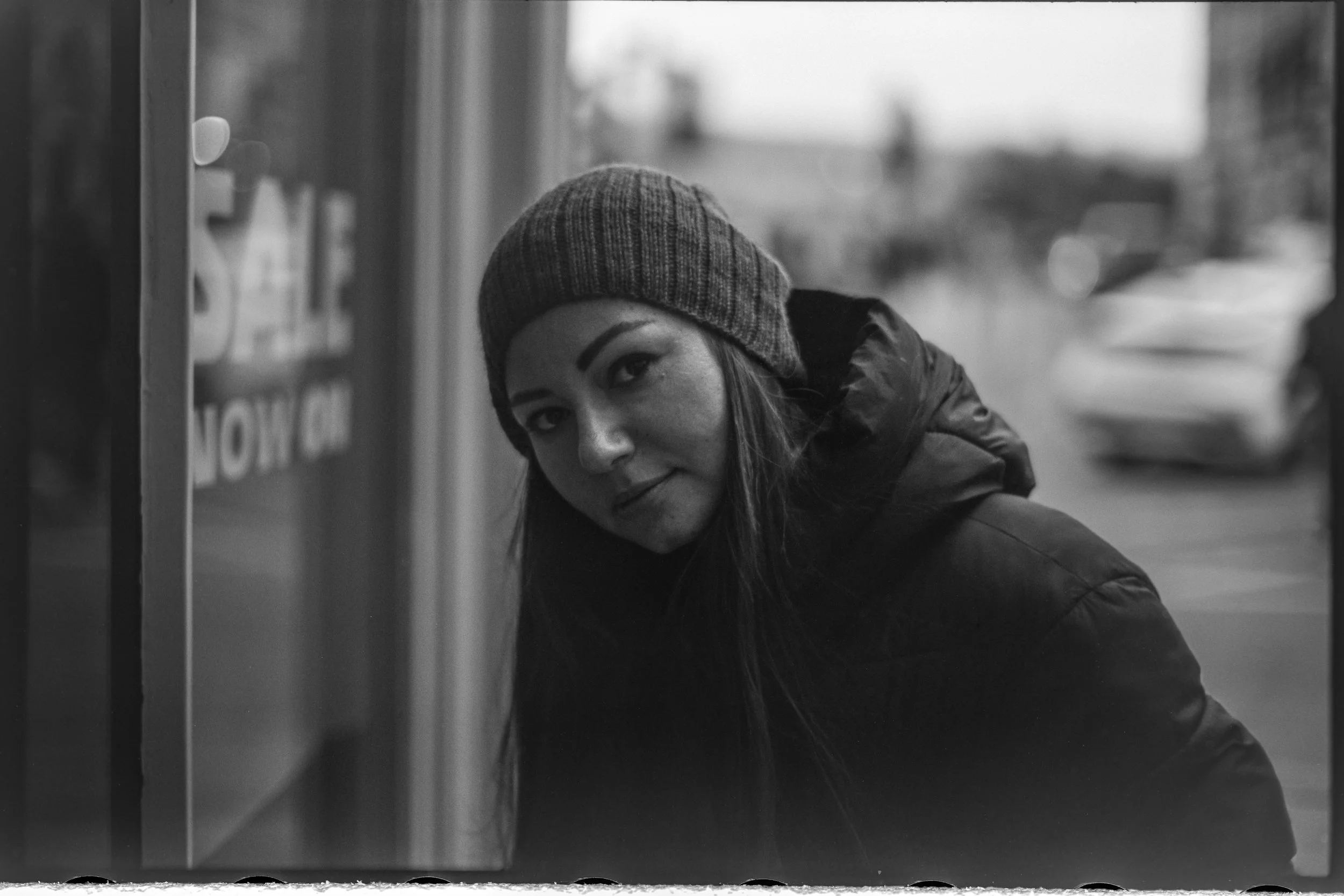 Portrait by a shop window in Bath, photographed on Babylon 13 at ISO 6 with a Voigtlander 50mm f/1.1 and developed in 510 Pyro.