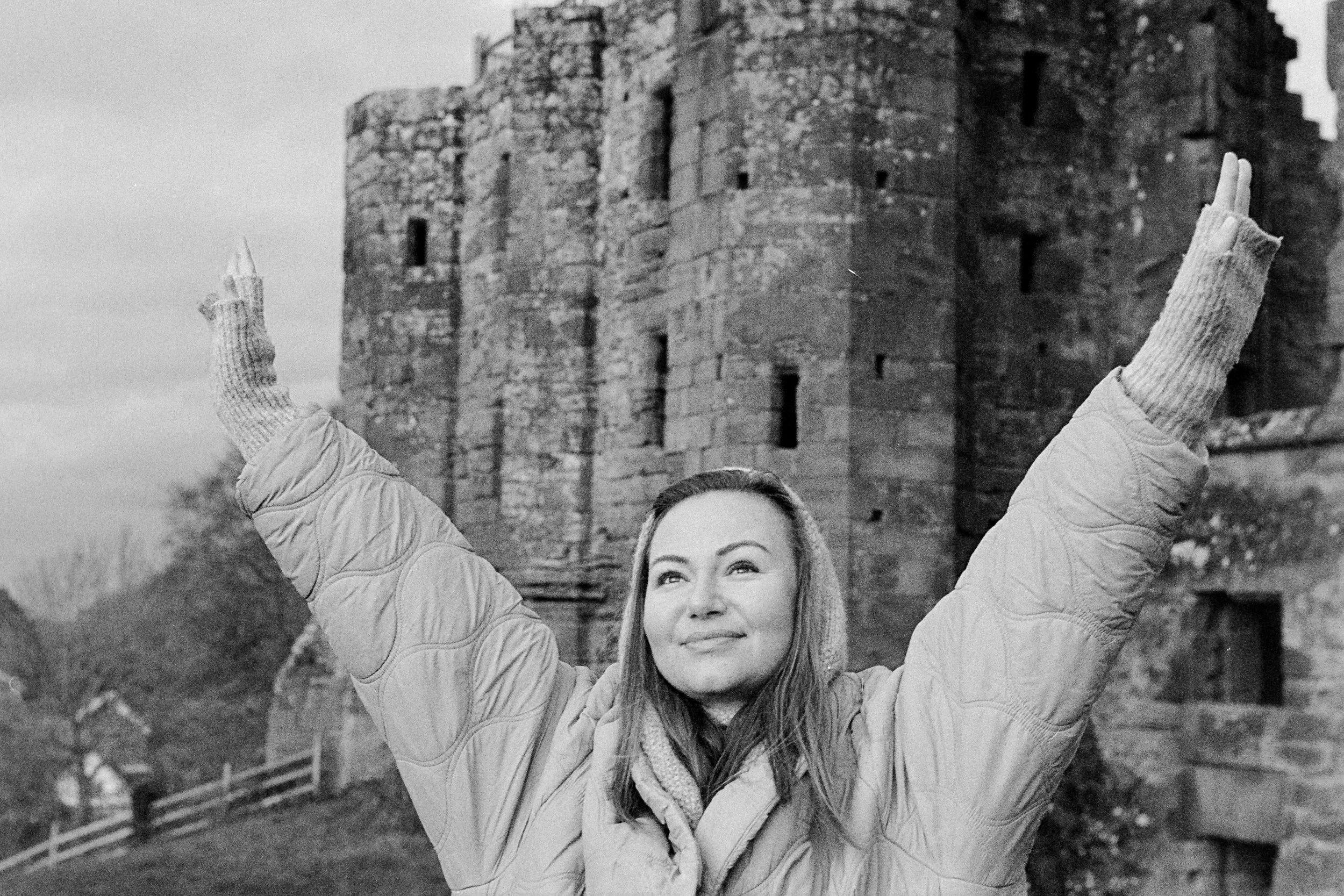 Black and white portrait of a woman with raised arms, developed from VISION3 500T film