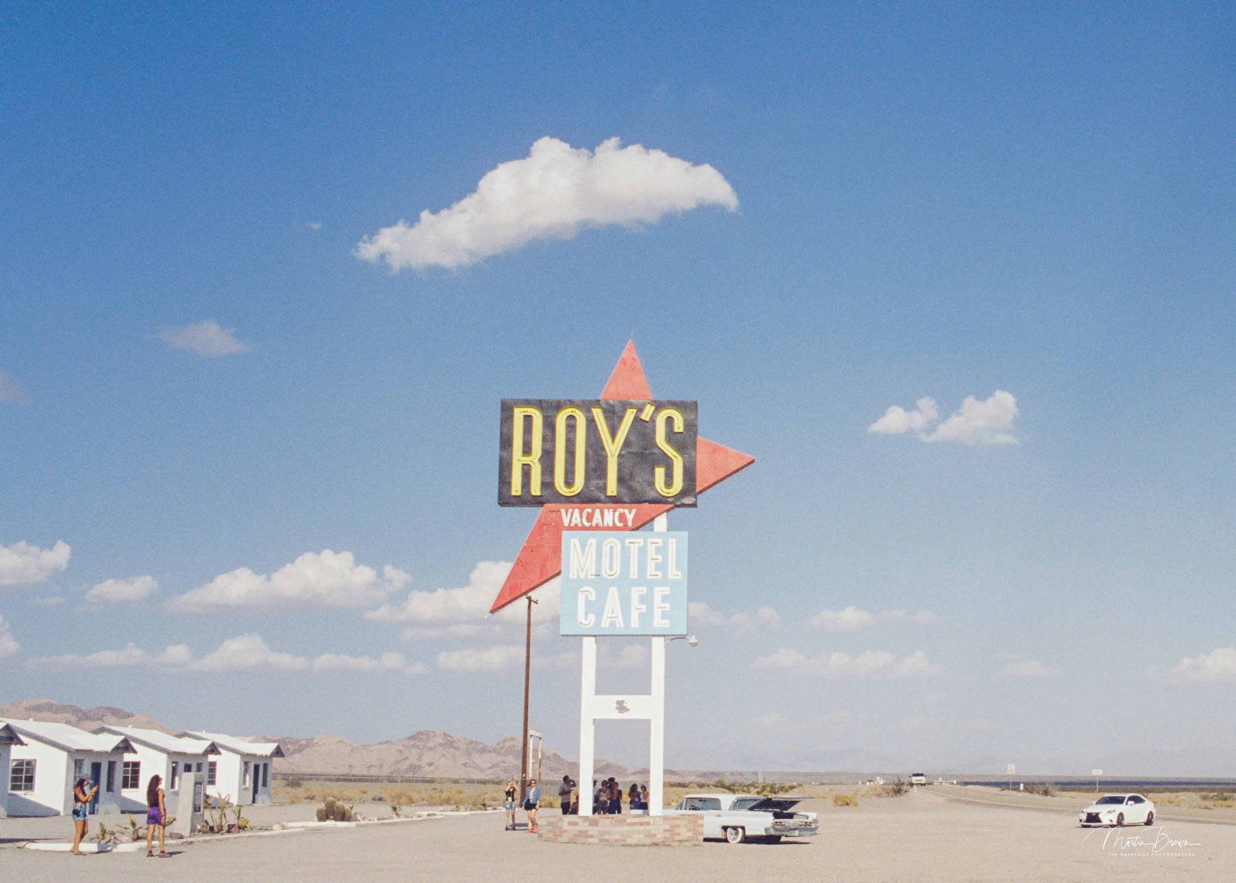 Roy’s Motel and Café sign on Route 66 in Amboy, shot on Silbersalz 50D film showing blue sky and desert tones.