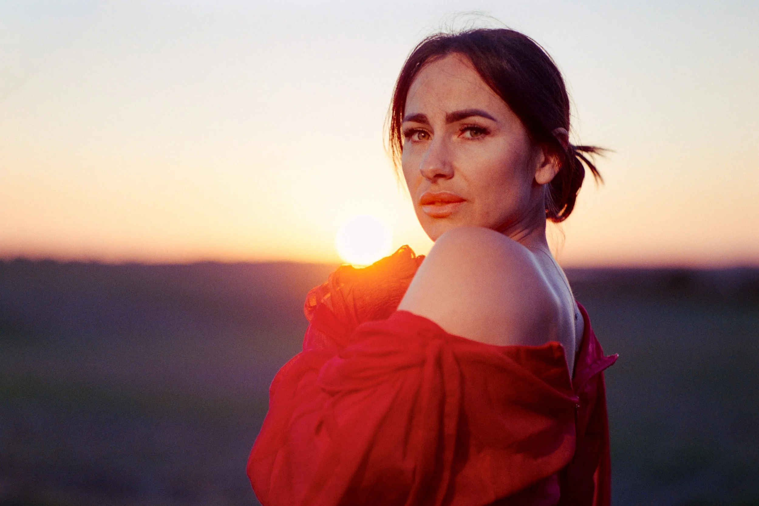 Woman in a red dress photographed outdoors during an on-location portrait session in Leamington Spa, Warwickshire.