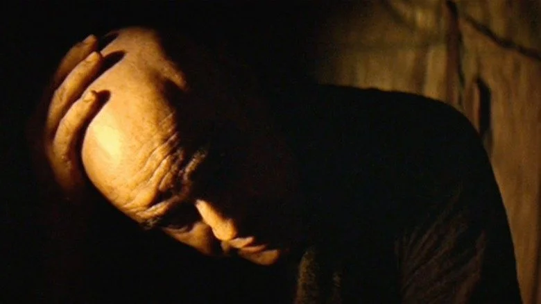 Marlon Brando in Apocalypse Now lit in deep shadow and directional key light, demonstrating high-contrast cinematic lighting