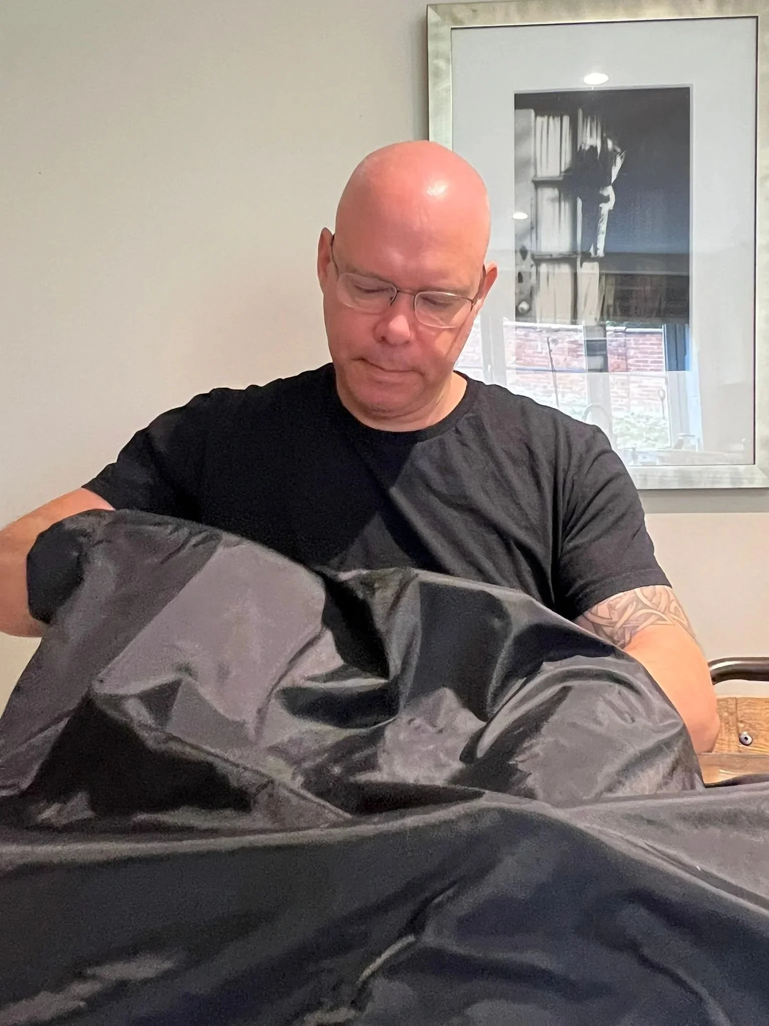 Martin Brown loading film into a developing tank inside a changing bag at Liquid Light Lab.