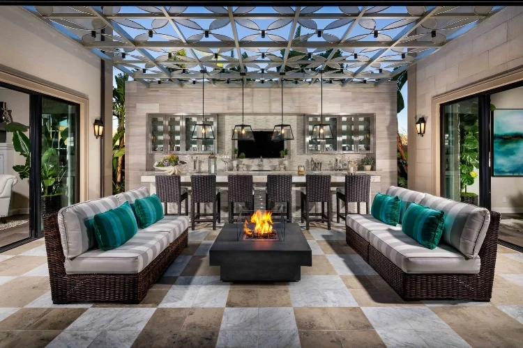 Cozy fireside seating and an outdoor kitchen- a dream for at-home entertaining.