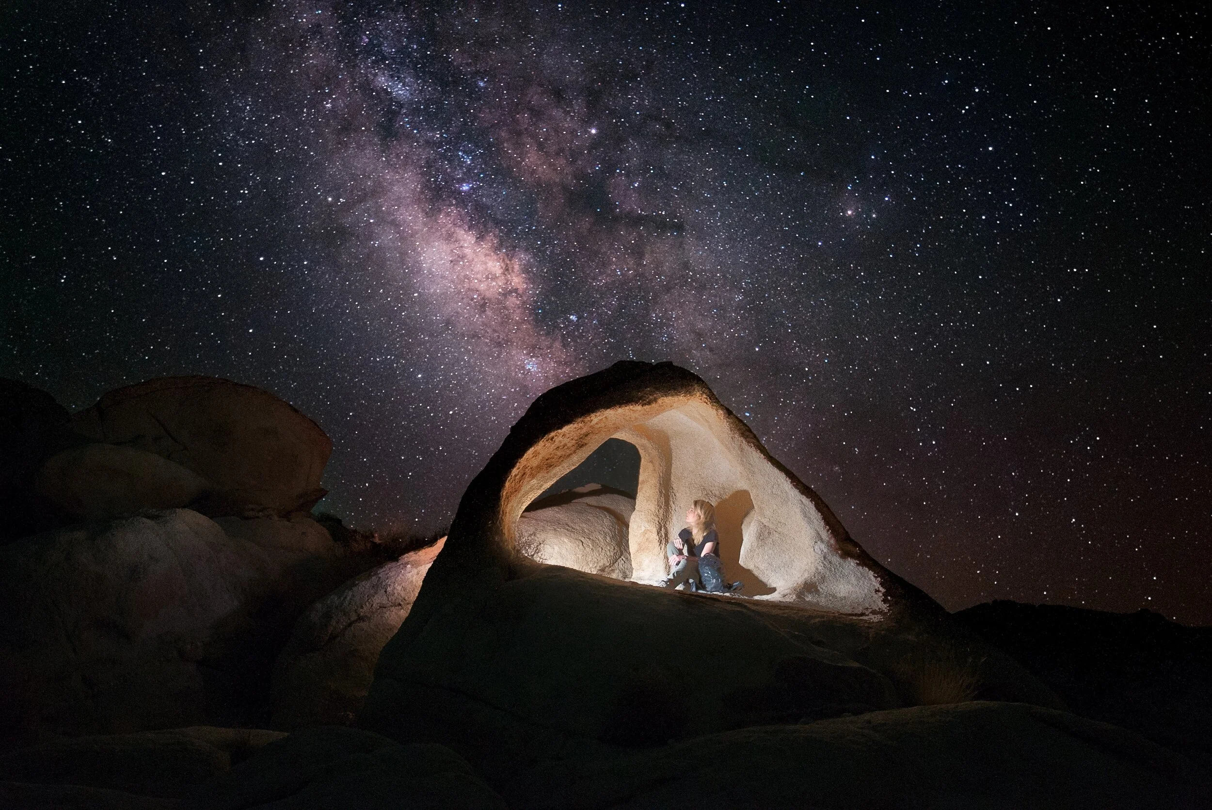 A woman in the desert stargazing