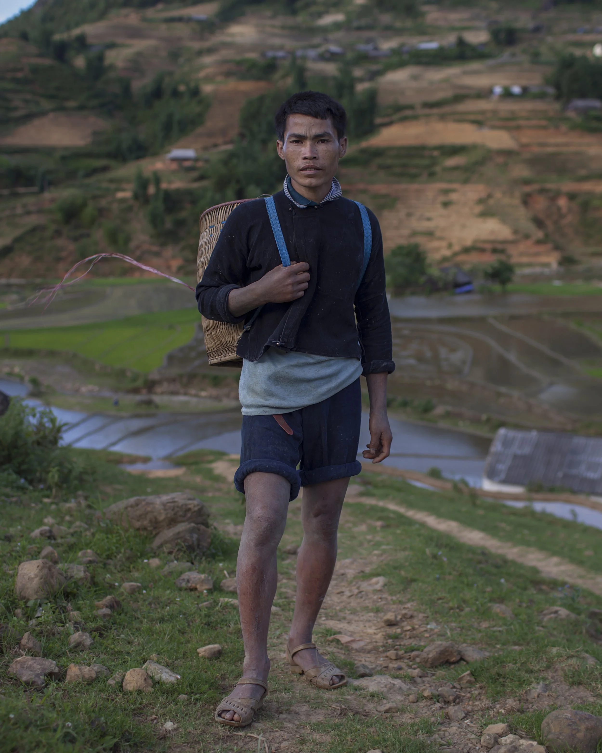 A young man from the Hmong ethnic group
walks back home through the mountains
of northern Vietnam, September 2011