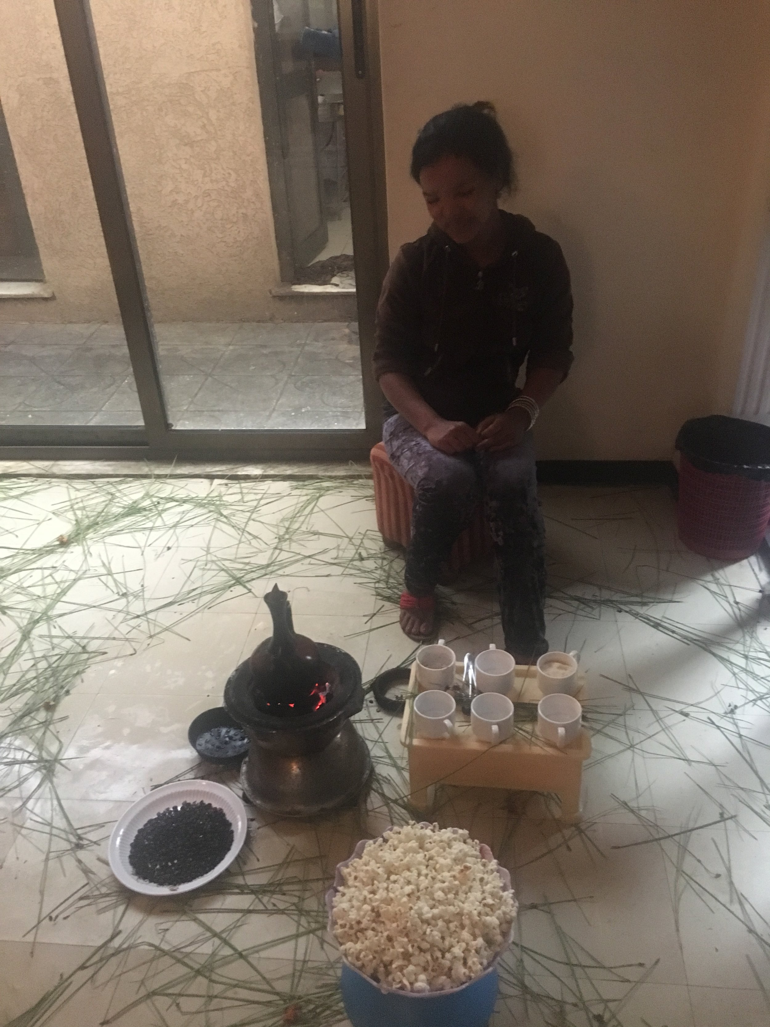 Tigist during a coffee ceremony, ready to serve.