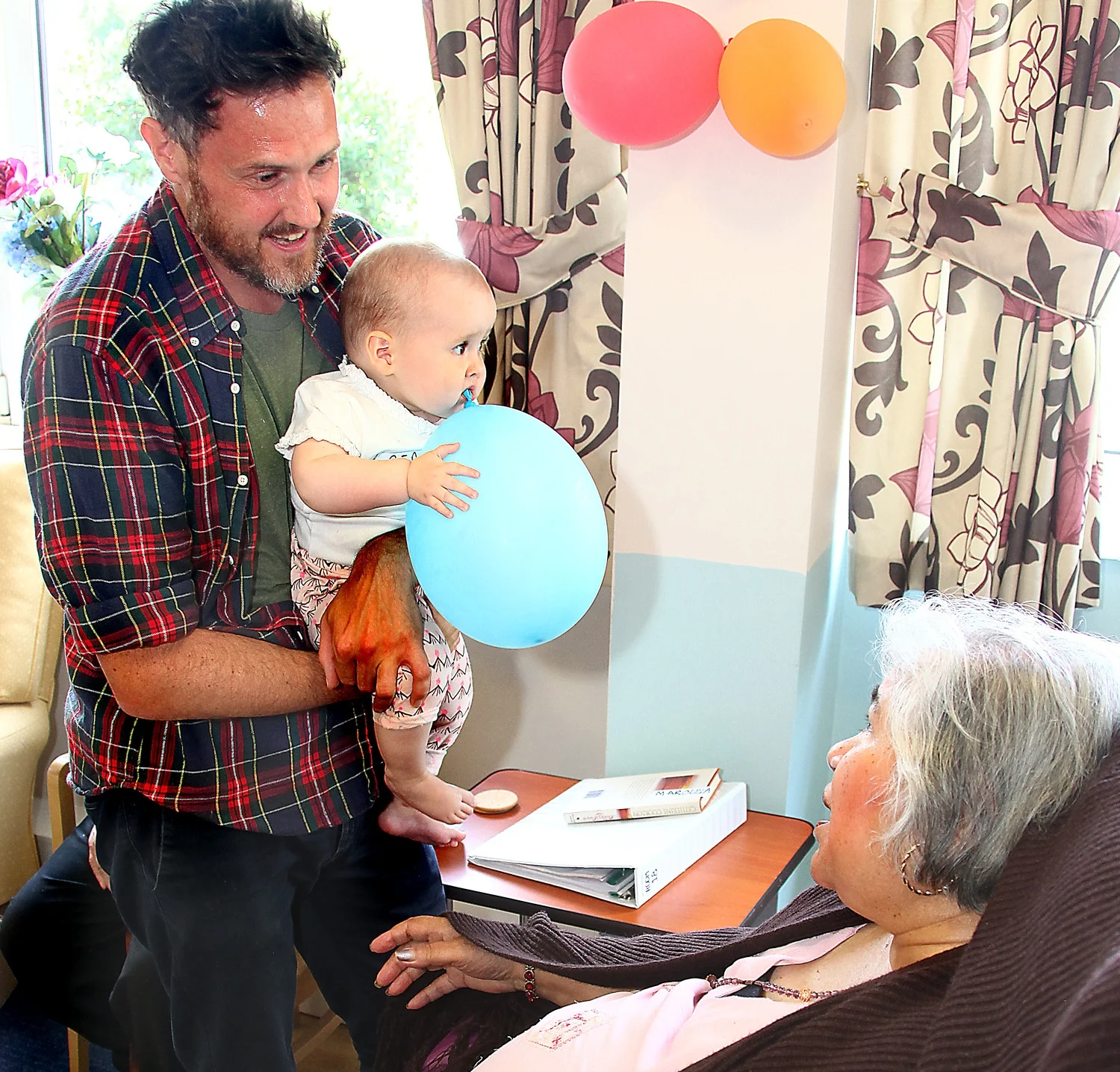 Sheila, Ross Wyld resident, with dad James and baby Beau