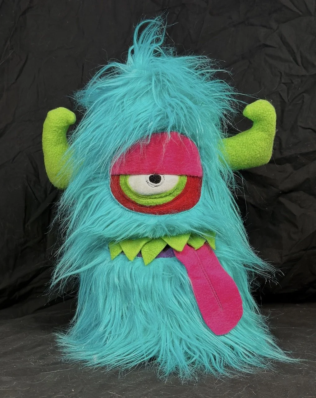 TURQUOISE ONE EYED MONSTER WITH POCKET MOUTH, HORNS