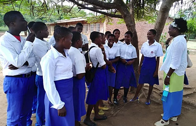 Cathy is interacting with some students at a secondary school. These students were telling stories of how WHY WAIT ? has changed their lives.