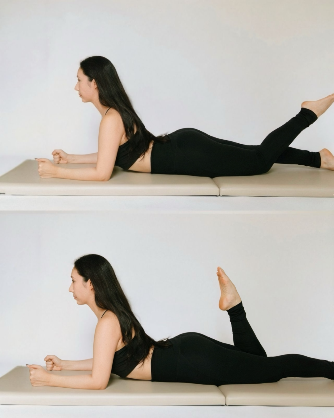 A woman in black workout clothes performs a prone leg lift exercise on a pilates mat, with her body supported on her forearms and one leg extended behind her, then lifting her leg upward in a two-part movement called the Single Leg Kicks.