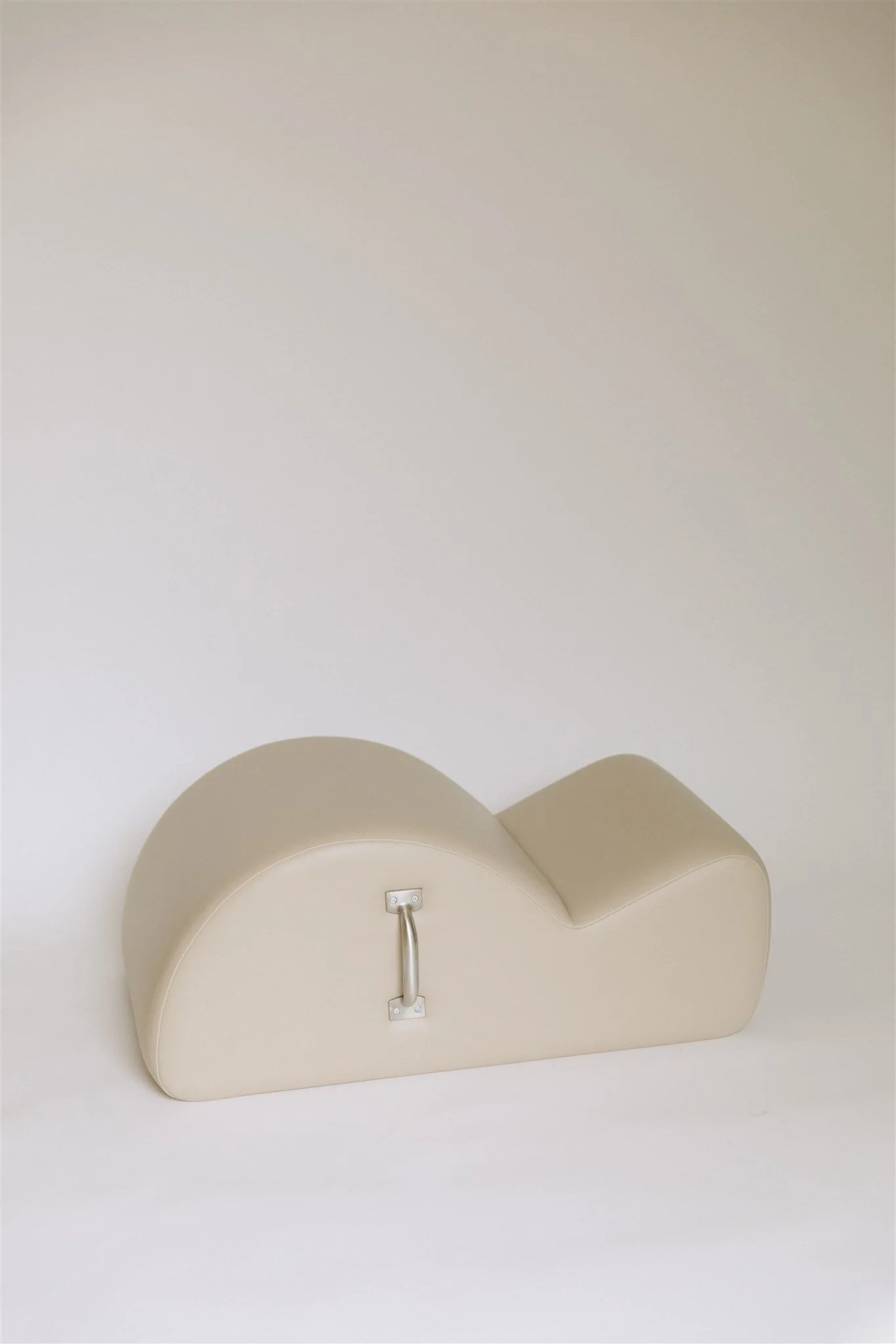 A beige Pilates Spine Corrector. The image is taken from a low angle looking downward.