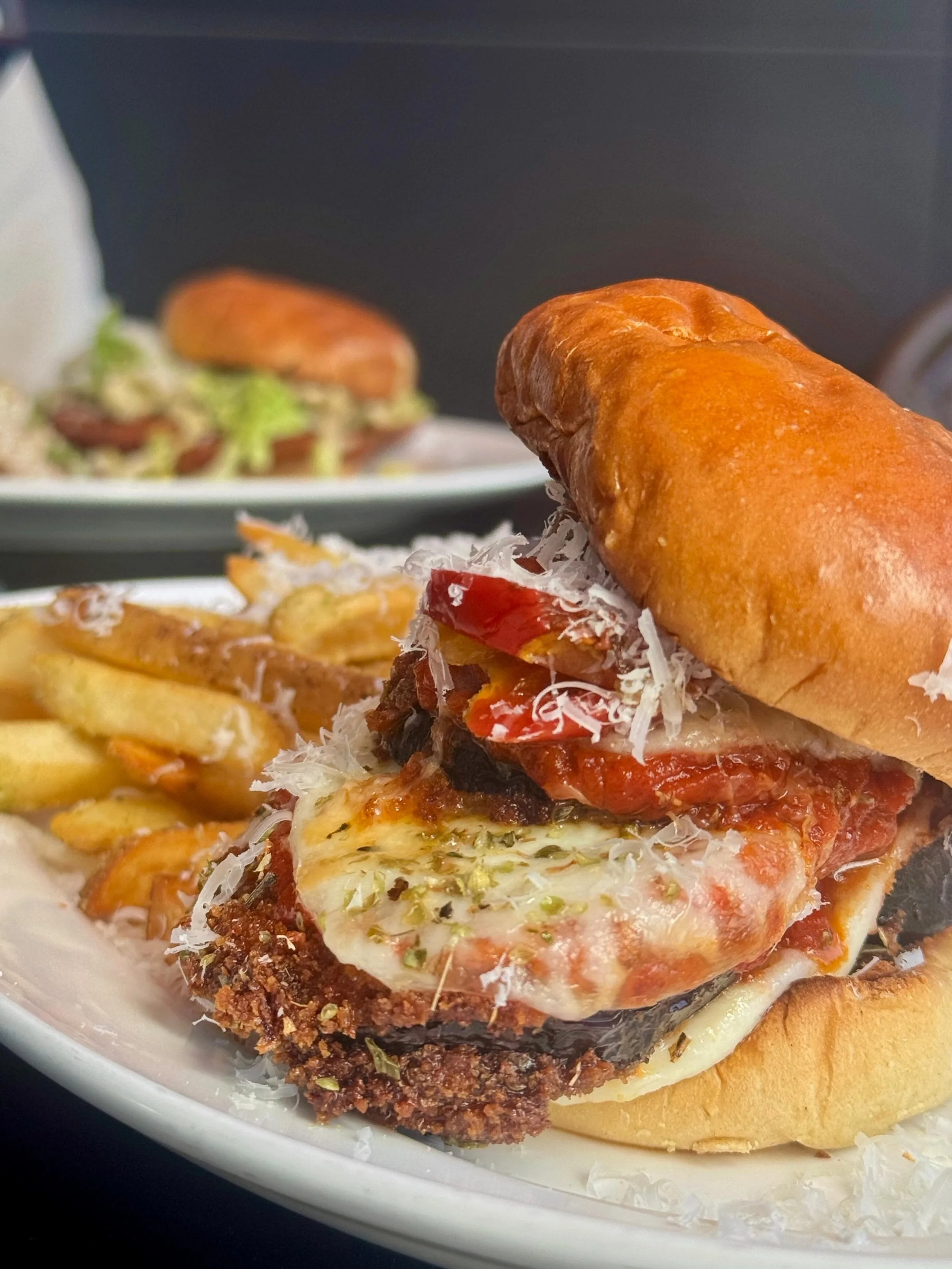 If you want a classic for lunch, our Eggplant Parmesan Sandwich could be the move: a potato bun with crispy, panko-breaded eggplant, house red sauce, melted mozzarella, Parmigiano-Reggiano, and pickled peppers. It comes served with a side of parmesan