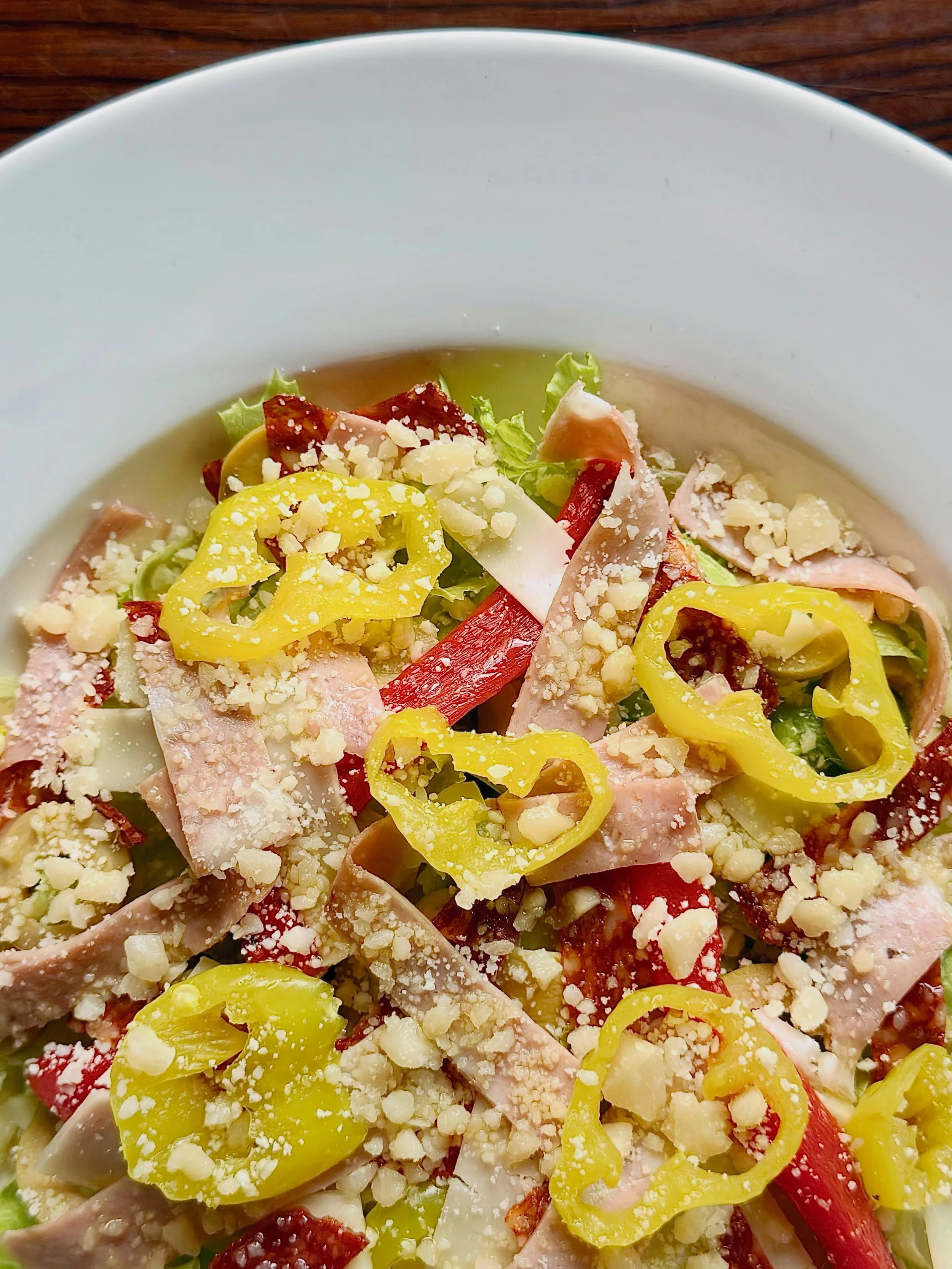 Inspired by the classic, old-school pizzeria salad, the Chopped Salad is only available during lunch service. It includes roma crunch lettuce, mortadella, pepperoni, provolone, Parmigiano-Reggiano, olives, roasted peppers, artichokes, banana peppers,