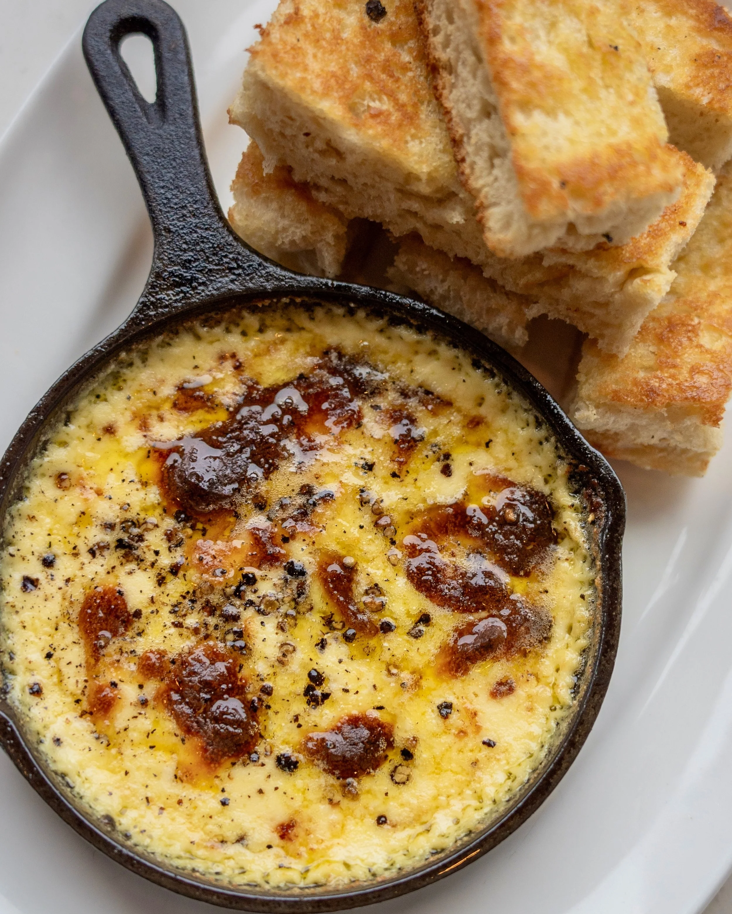 May we recommend a starter for the table? The Cast Iron Fonduta is a craveable cheese dip with fontina, extra virgin olive oil, and our house focaccia.

Order a bottle of wine for the table and you can make it a sip-and-dip kind of evening.
