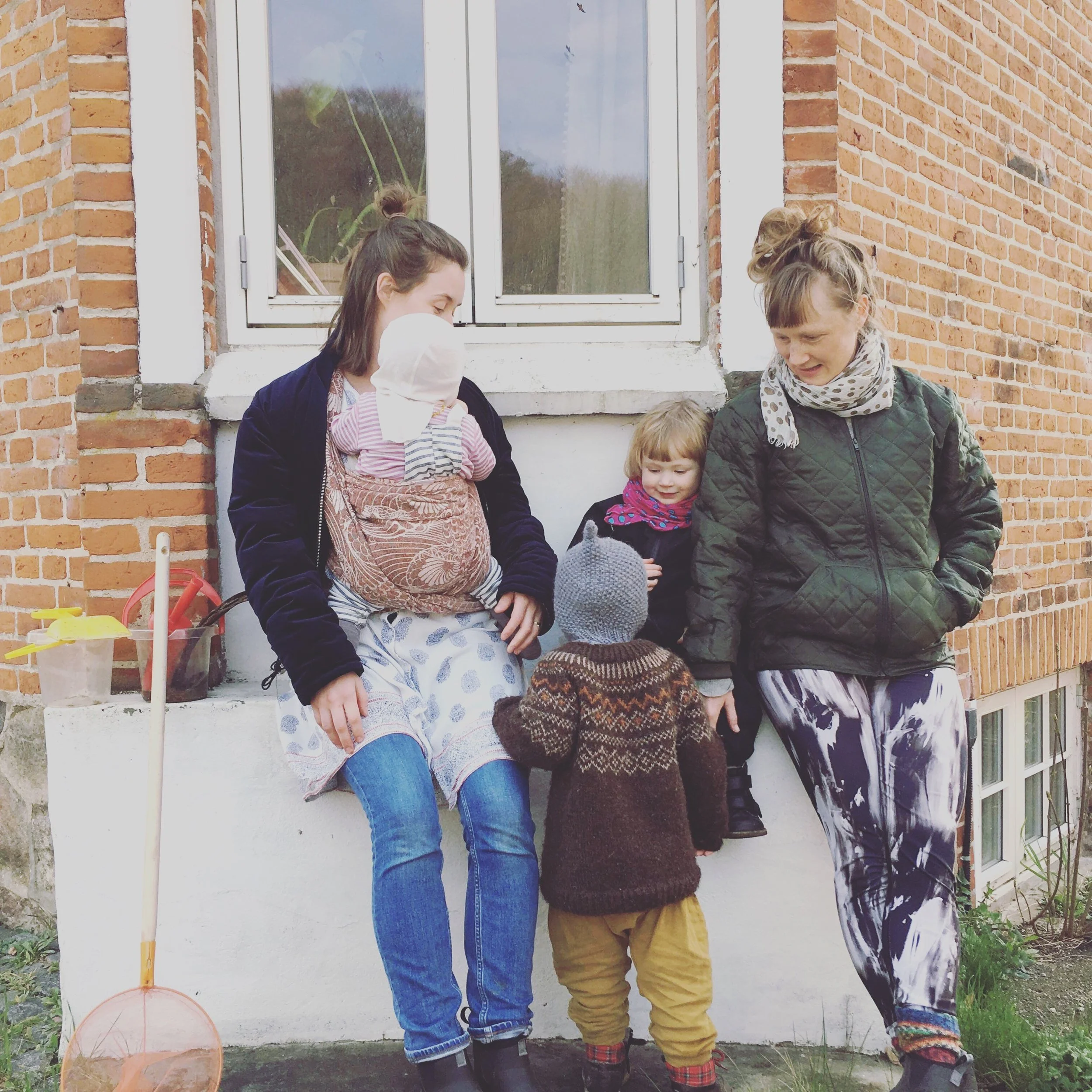 Maria sammen med sine to børn - og Lykke med sin datter - udenfor huset i Laven.