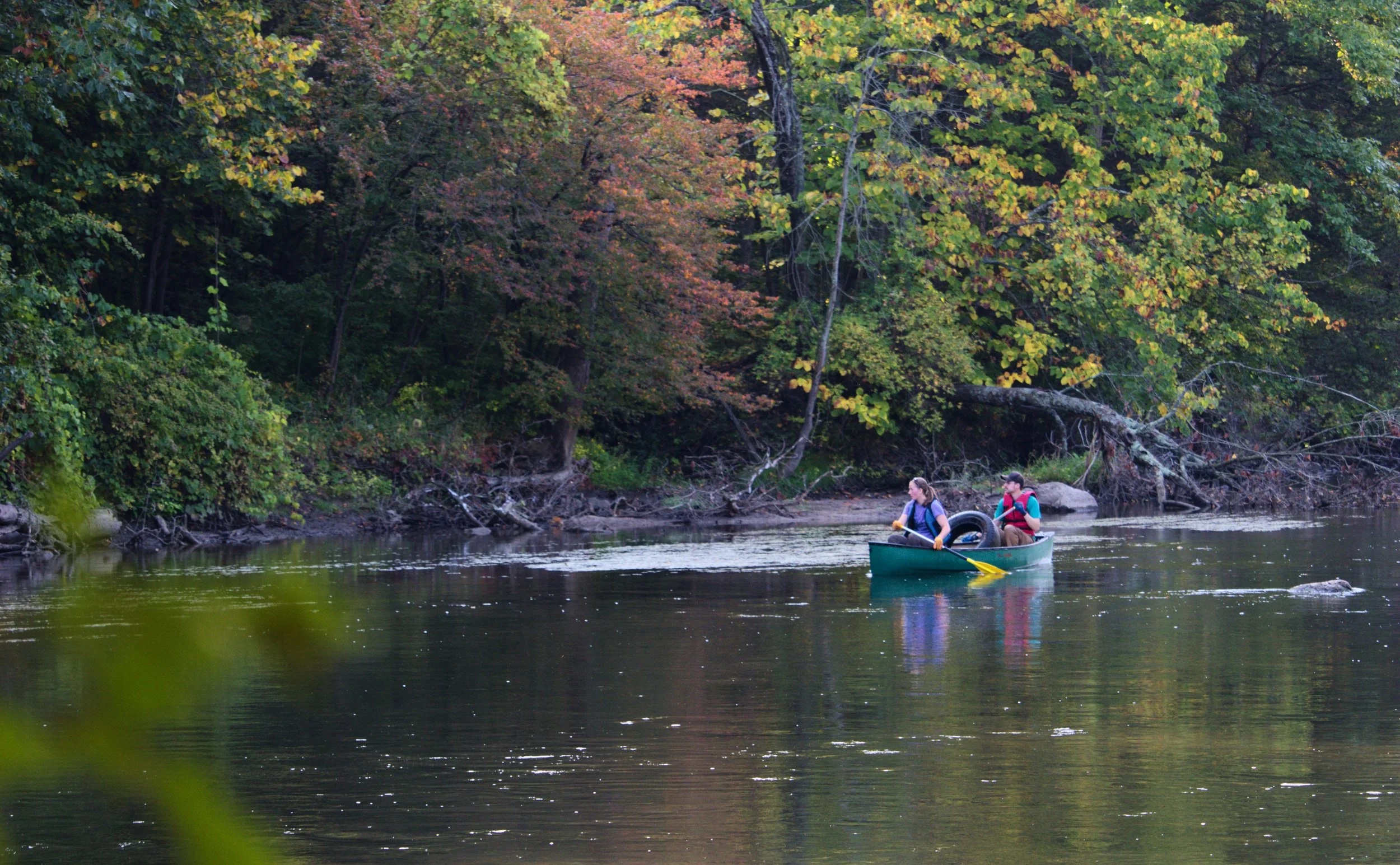 Alex and Korie Ebenstein inspect the riverbank as they pass. Both of them graduated from GVSU, Alex in Natural Resources Management and Korie in Biology. They've been cleaning up the river together for a total of six years.