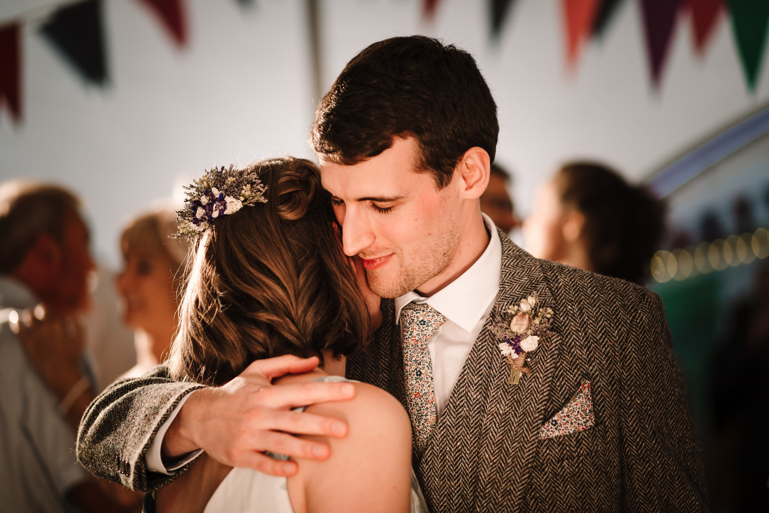 A groom hugging the bride in a marquee in Yorkshire