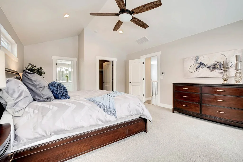 View of the master bedroom looking toward the master closet and attached bathroom.