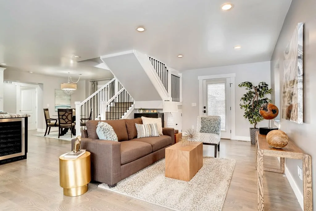 View of the living area and central staircase which anchors and organizes the spaces.