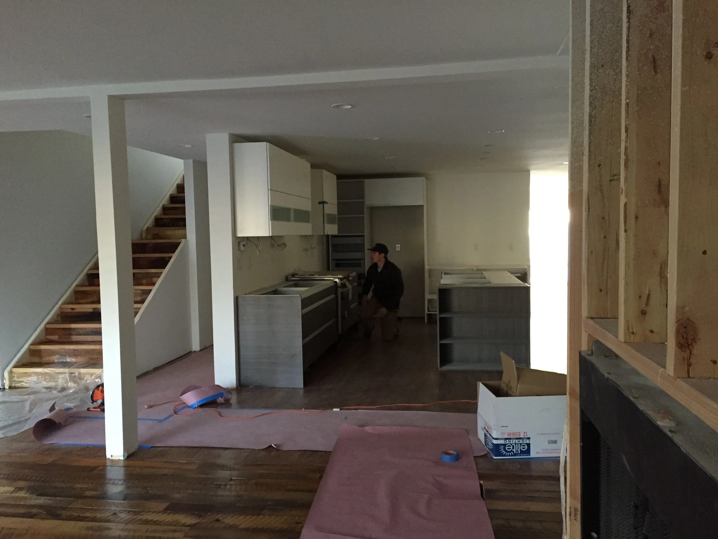 View of new open floor plan with new stair and kitchen (under construction)