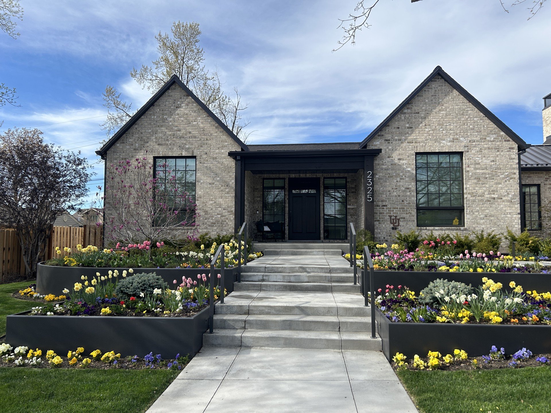 These colorful, cheerful flowers we planted in the front yard create a beautiful path for our clients to be welcomed home. #flowers #flowerlovers #spring #blooms #landscapedesign #landscape #landscapers #utahlandscapers #plantingbeds #utah